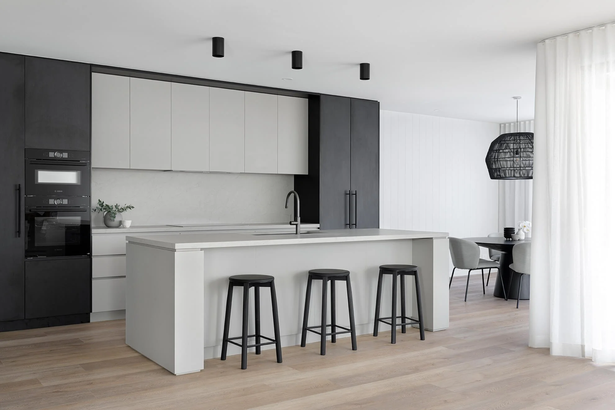 Black and grey open plan kitchen showing floor plan layout and movement between zones