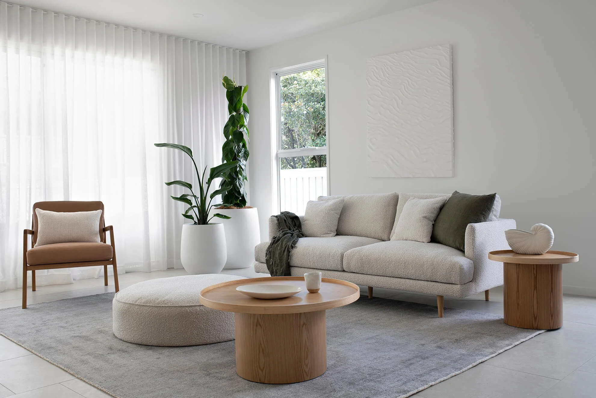 Living room furniture and grey floor rug in coral house living room design