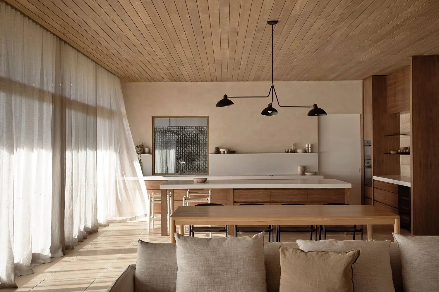 Porcelain kitchen island bench and engineered wooden floors with white sheer curtains in kitchen design