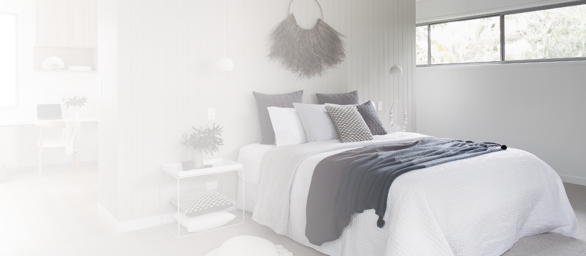 A coastal master bedroom with a raked-timber wall feature and adjoining study nook, designed by Zephyr and Stone