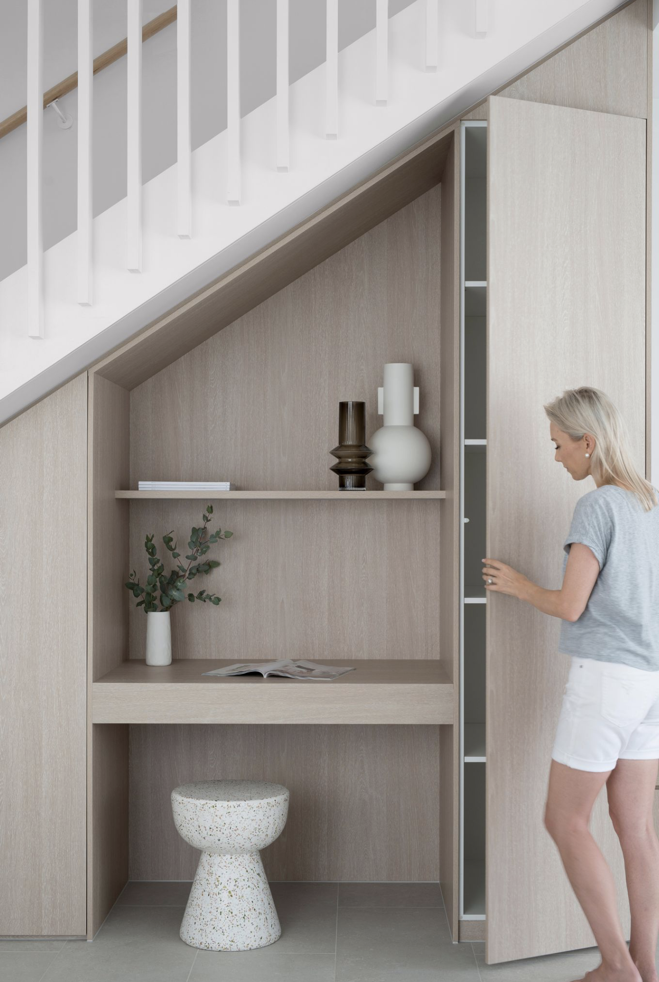 Under-stairs storage with a built-in study nook, open shelf and tall cupboard in timber joinery.