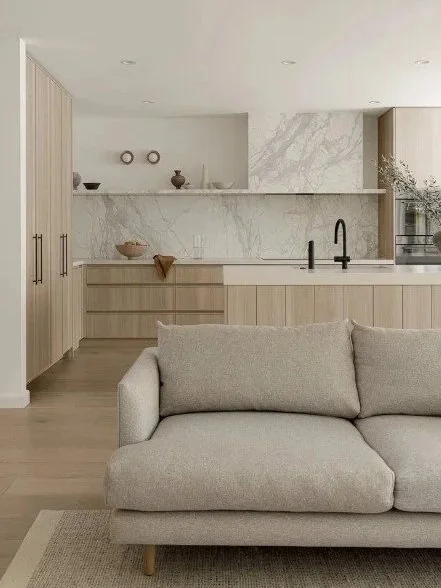 Open plan kitchen and living area with the sofa and kitchen zones visible in one frame