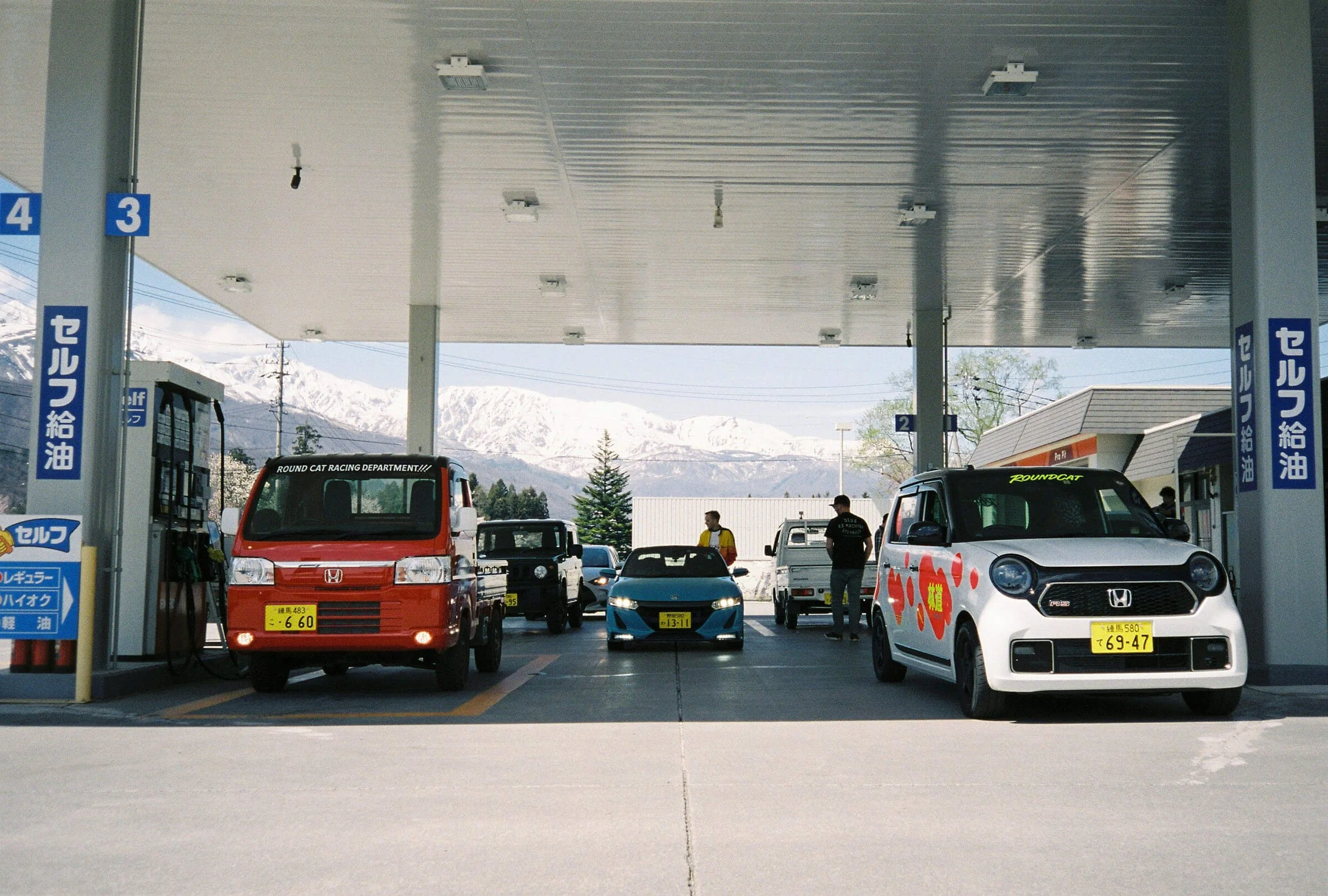 Kei cars fueling in Hakuba snowcovered mountains RoundCat Rally.jpg