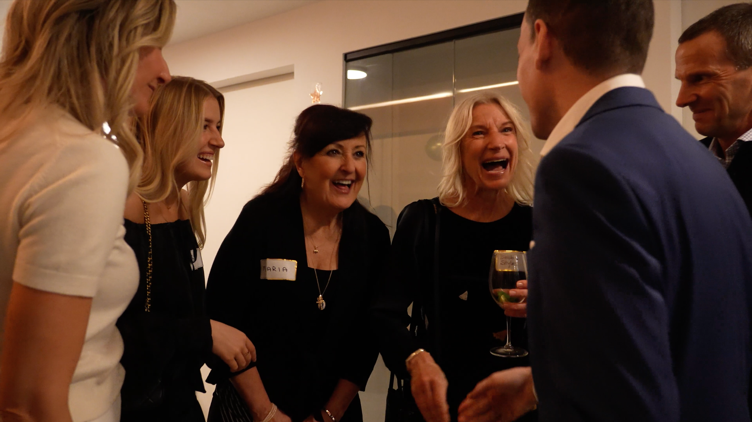 Group of guests laughing as Patrick Gregoire performs close-up mind reading at an event