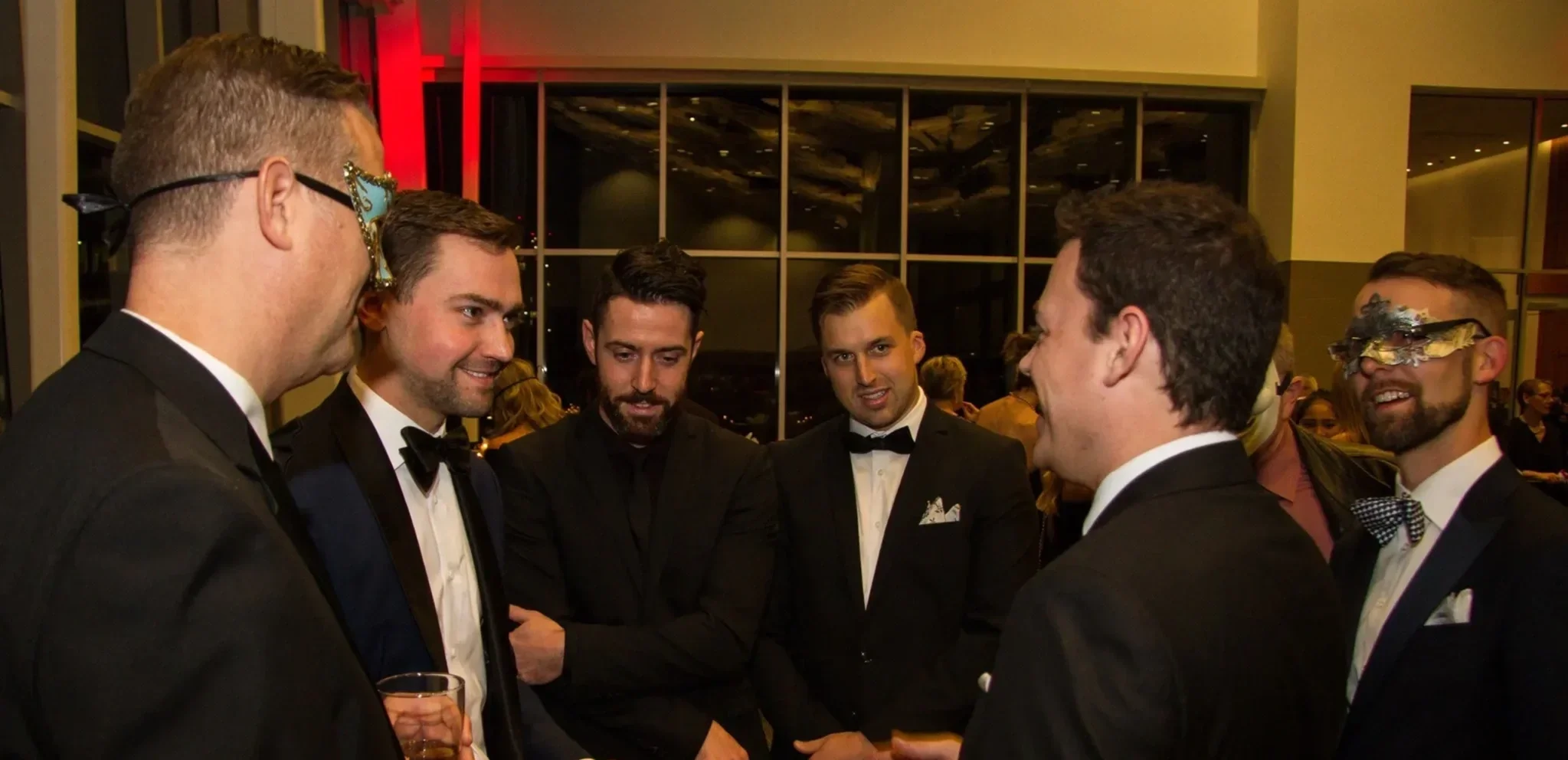 Guests in black-tie attire watching Patrick Gregoire perform close-up mentalism at a gala