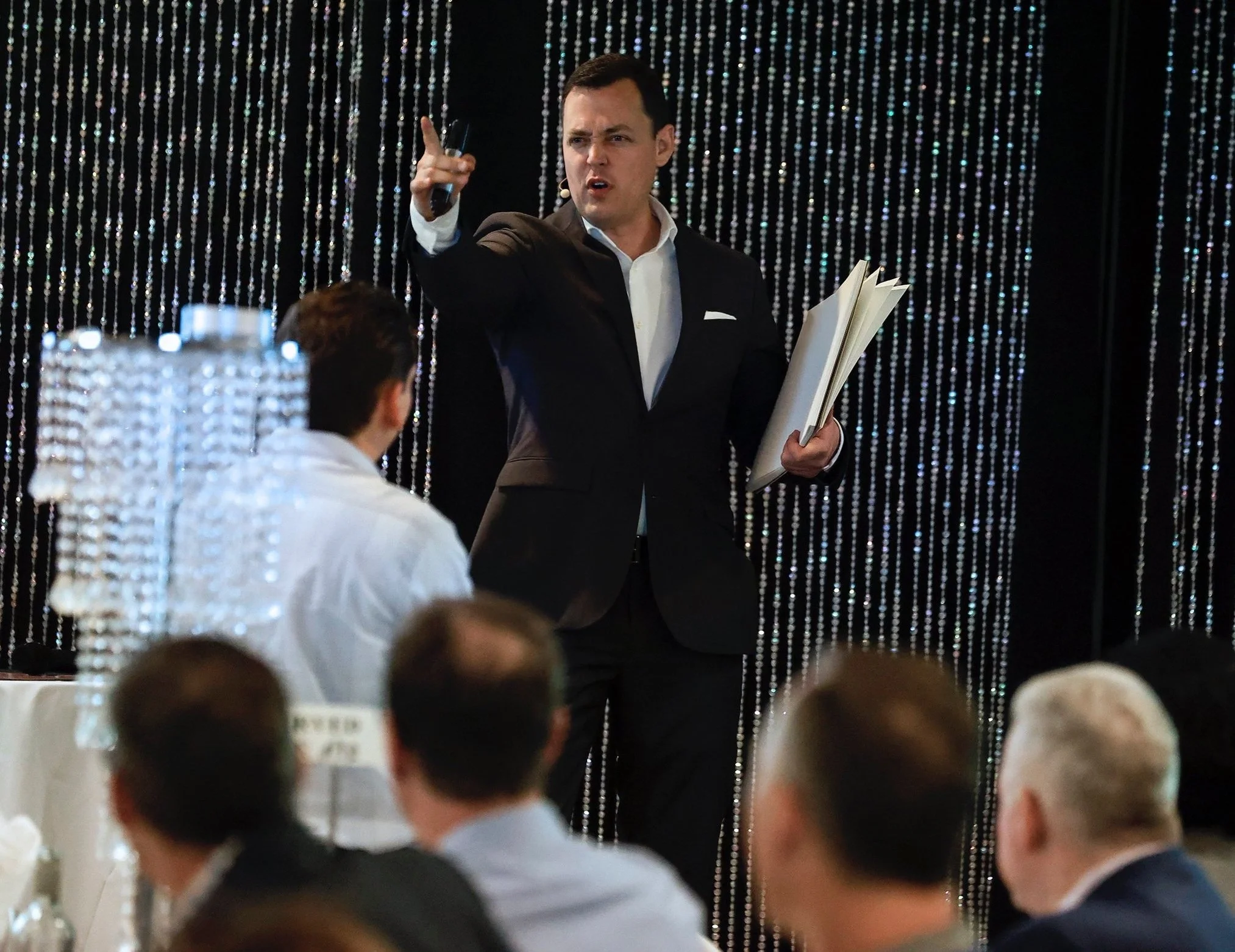 Winnipeg corporate mentalist Patrick Gregoire standing on stage at a corporate event reading minds