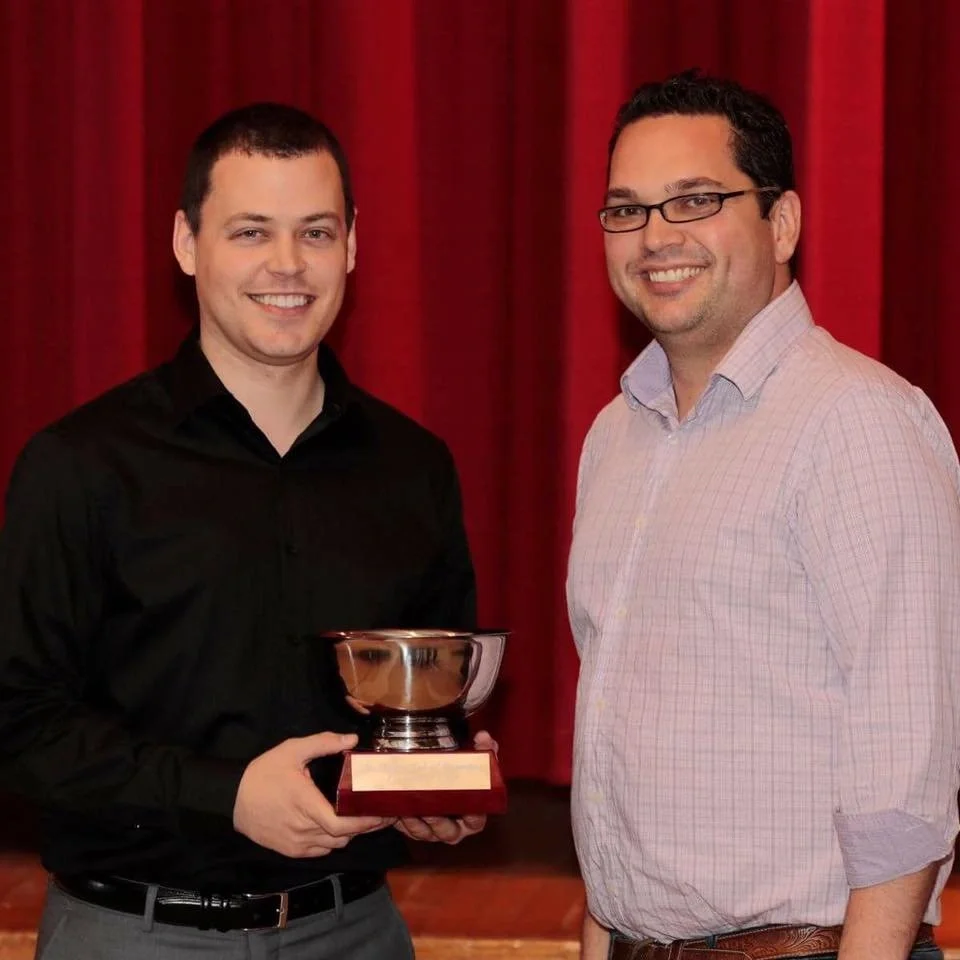 Winnipeg corporate magician Patrick Gregoire receiving a trophy as winner of the Magic Club of Winnipeg magic competition