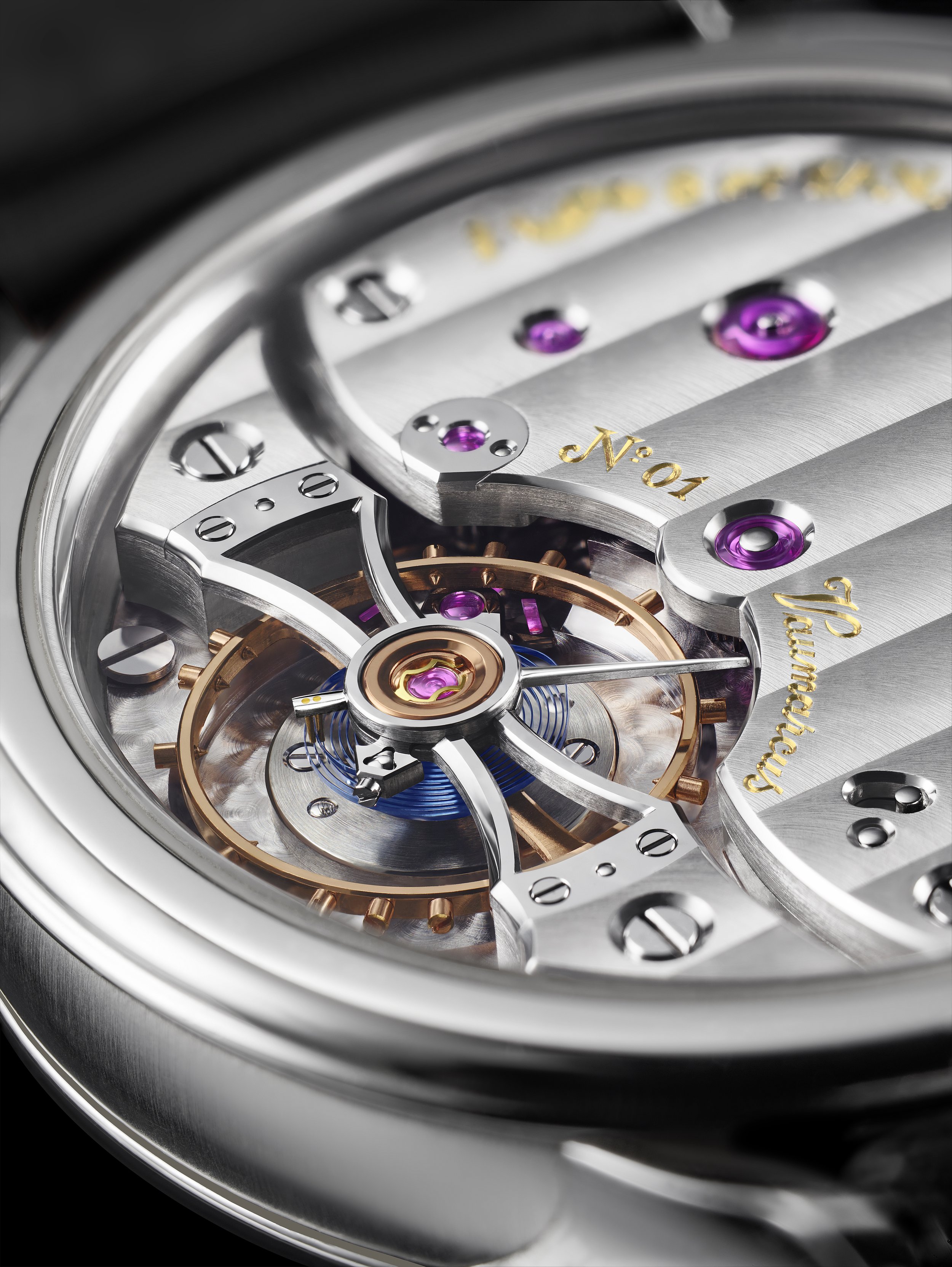 Close-up of a luxury mechanical watch movement, showing intricate gears, jewel bearings, and metal components with engraved writing.