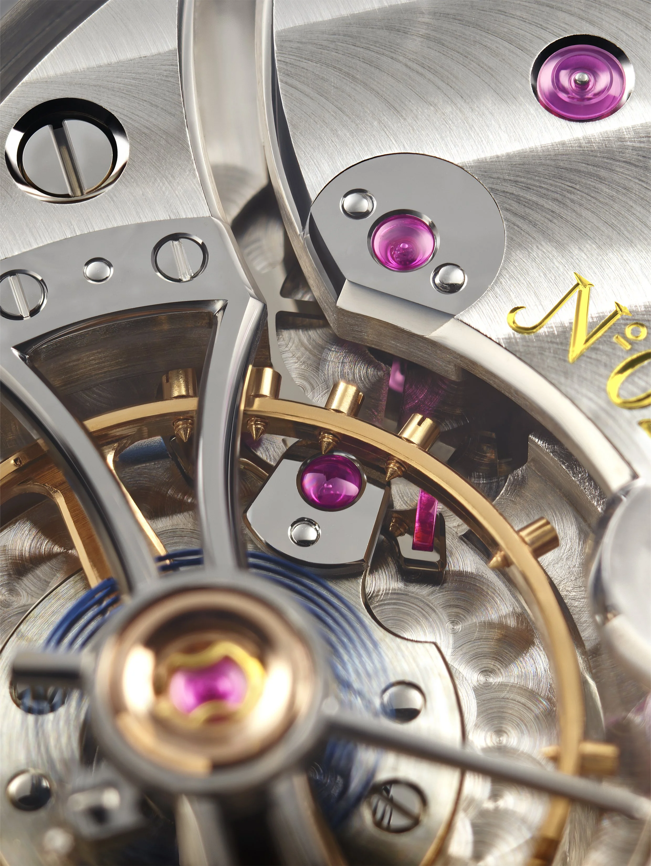 Close-up of the intricate gears, jewel bearings, and components inside a luxury watch movement.