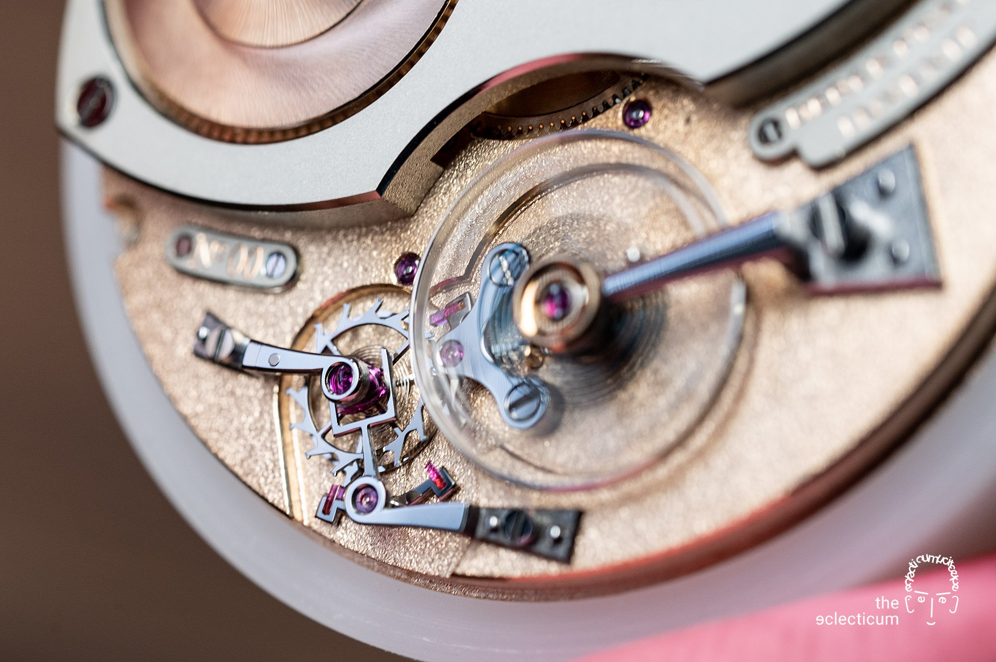 Close-up of a luxury watch movement showcasing gears, jewels, and intricate mechanical components.