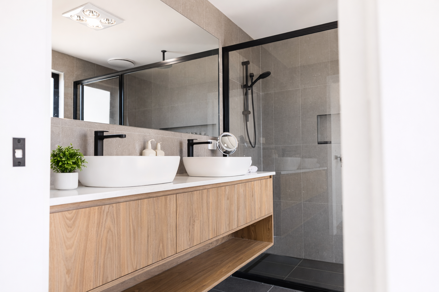 Modern bathroom with natural accents.png