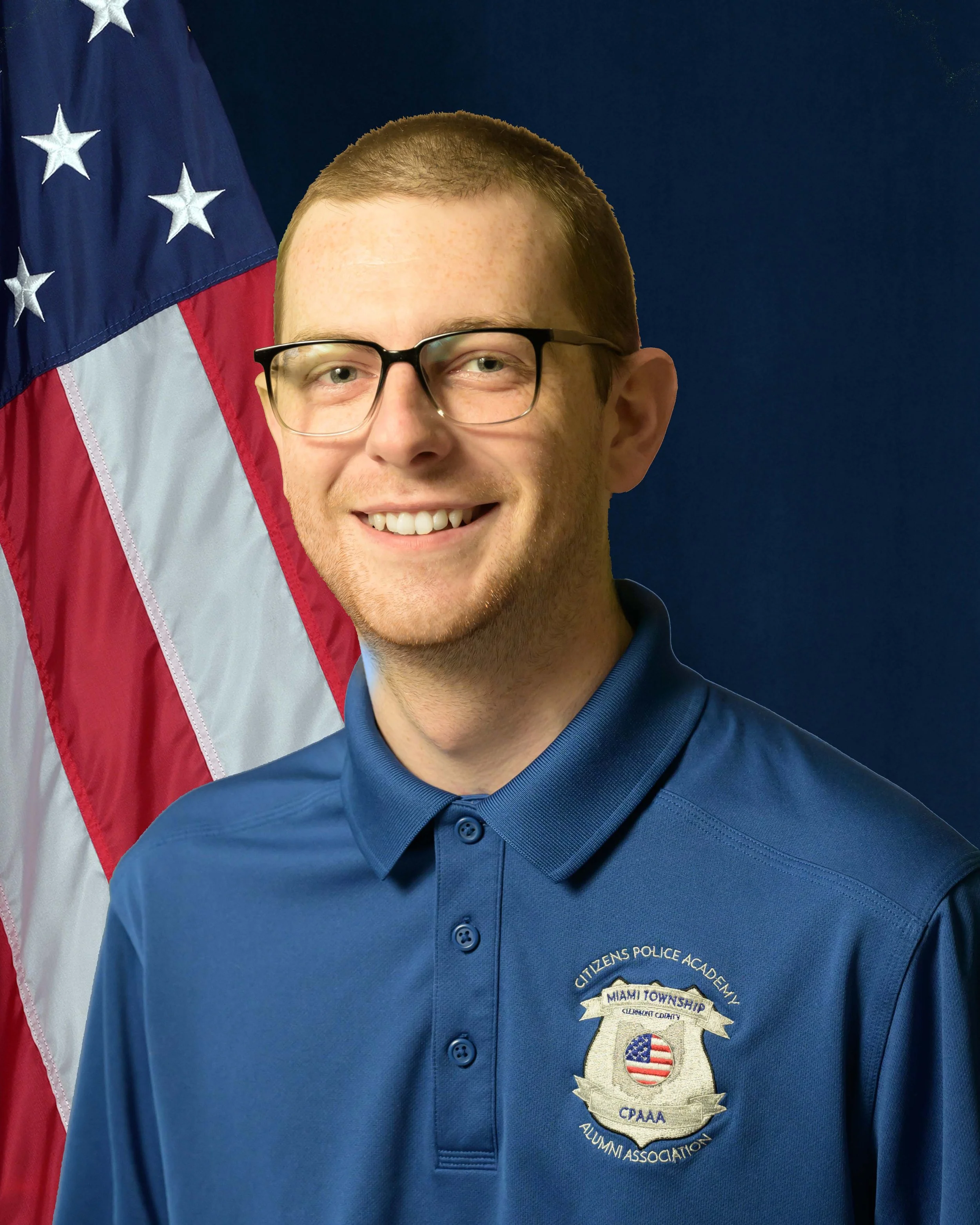 A portrait of Joshua Ferris standing in front of an American Flag