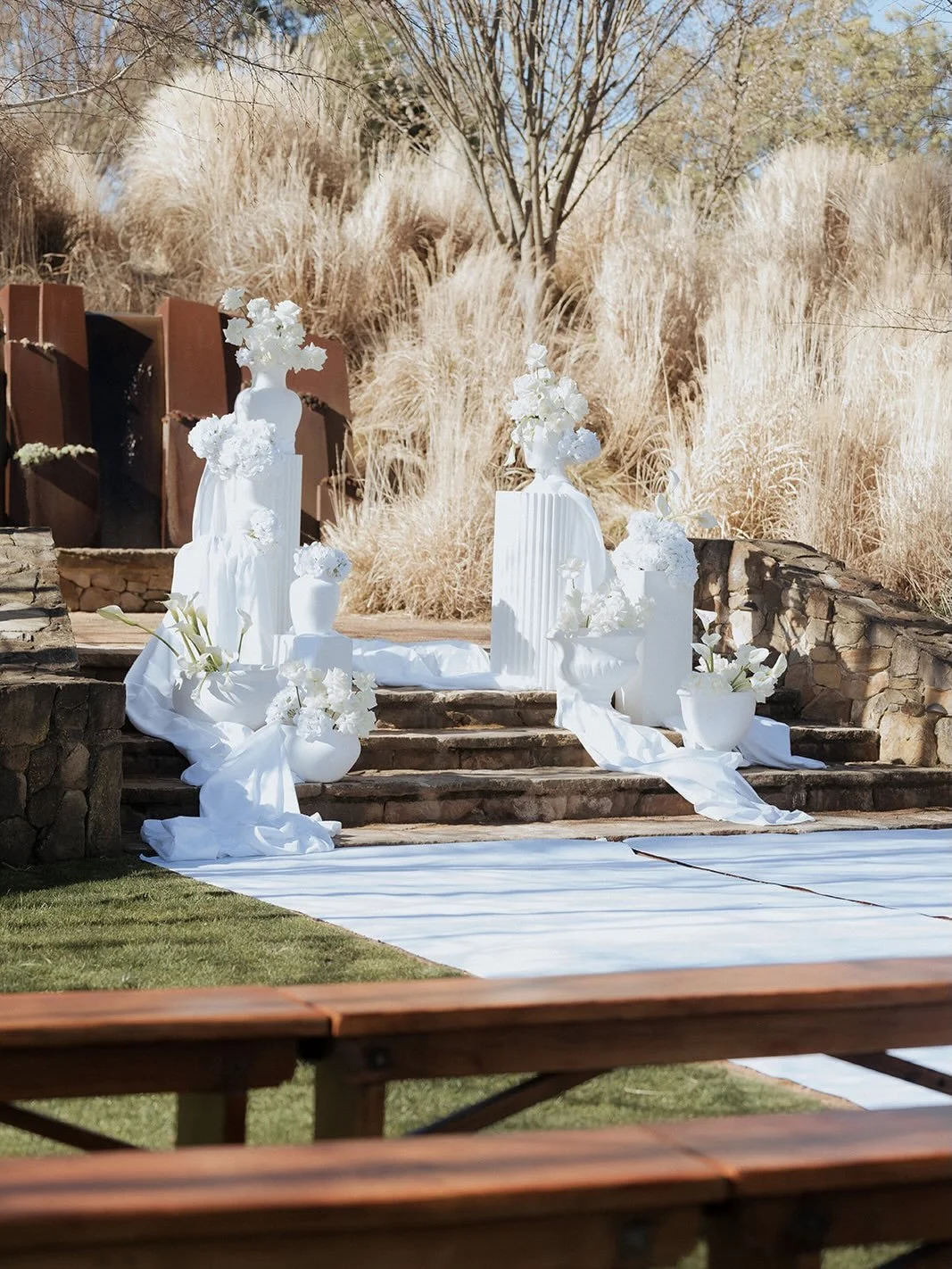 Soft, sculptural and intentionally layered ceremony set up for Rene &amp; Gian 🤍

For this ceremony we wanted the stairs at The Stables to feel almost transformed with white plinths &amp; urns, flowing fabric and floral moments placed throughout the