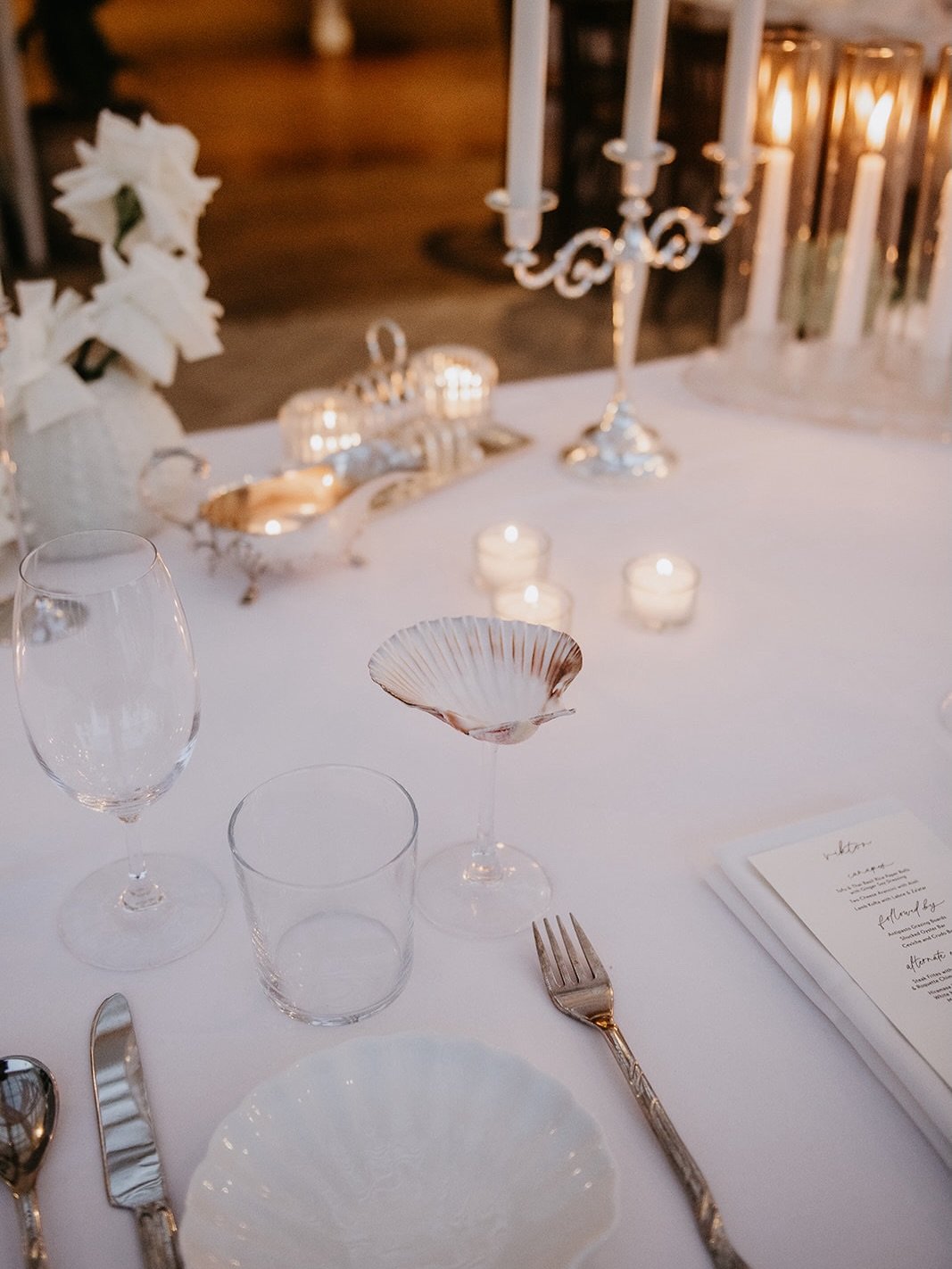 For Ashley &amp; Erik&rsquo;s reception, we incorporated the sweetest oceanic details with candlelit shells, coral and sand all a sunset colour palette 🐚 It complemented the beautiful @dunespalmbeach so perfectly! 
.
Dream team
Flowers, styling, des