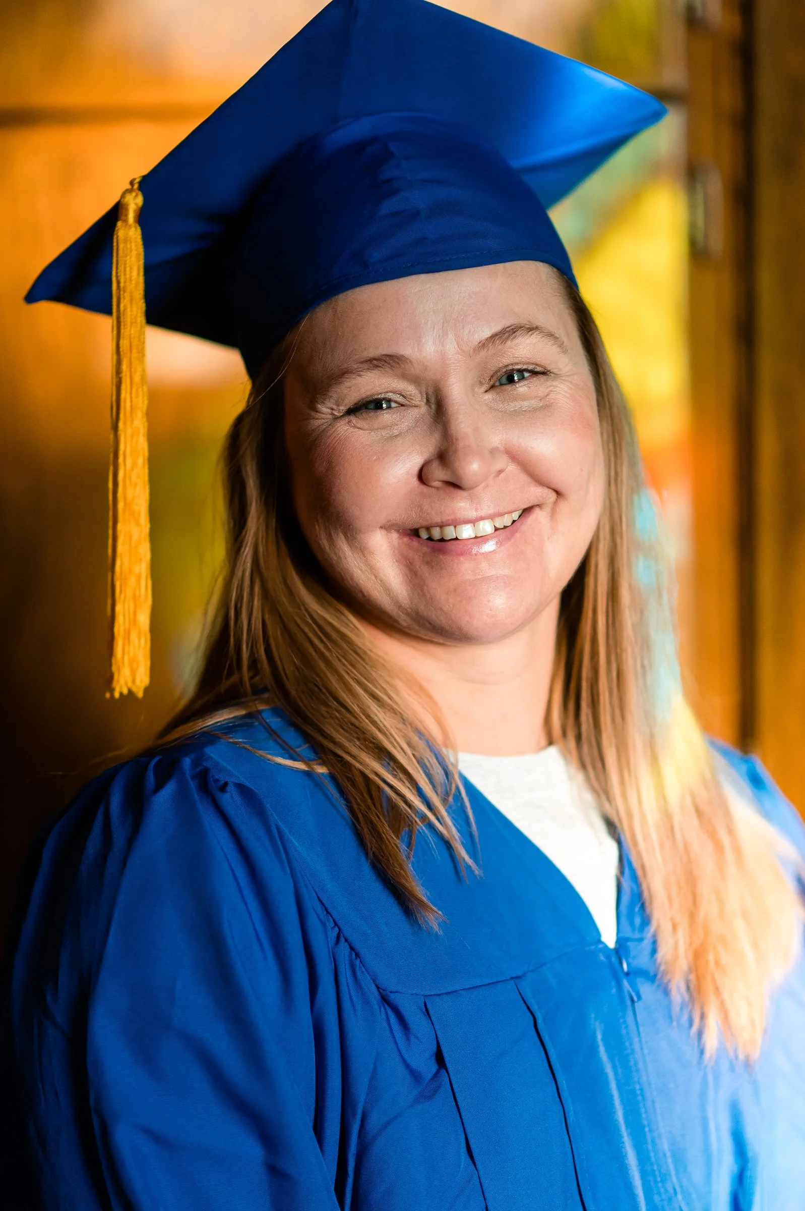 RISE graduate smiles during her in-prison program graduation ceremony.