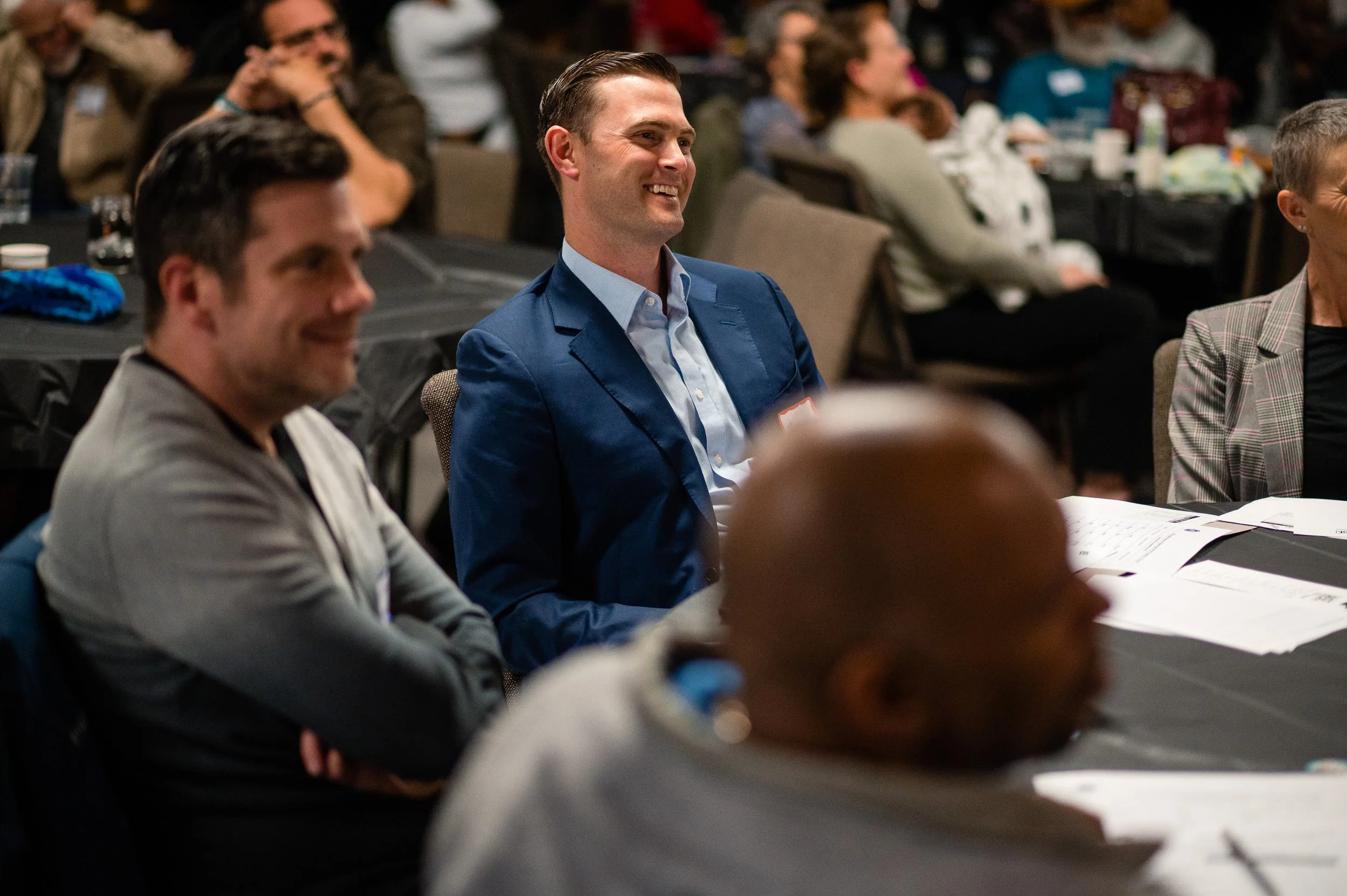 RISE volunteer listens to a RISE Business Academy pitch competition.