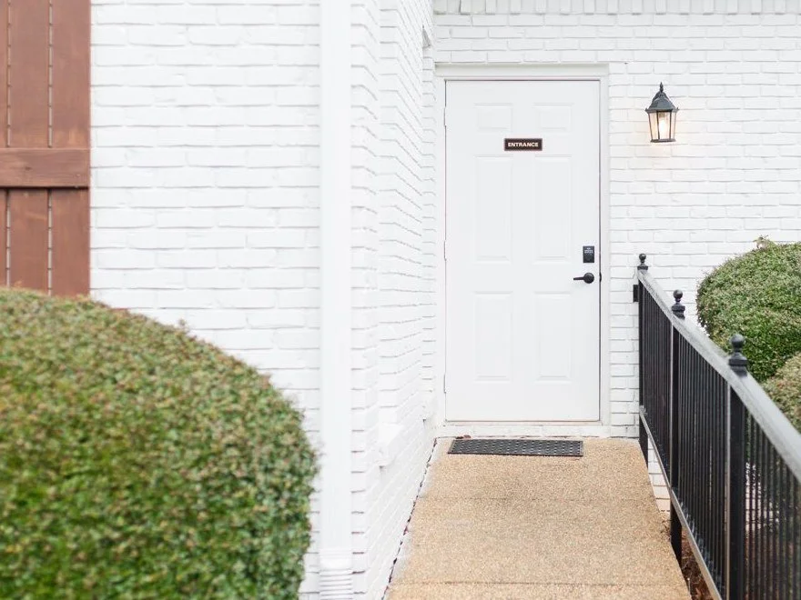 A brick walkway leading to the welcoming front door of a Soul Story Therapy office