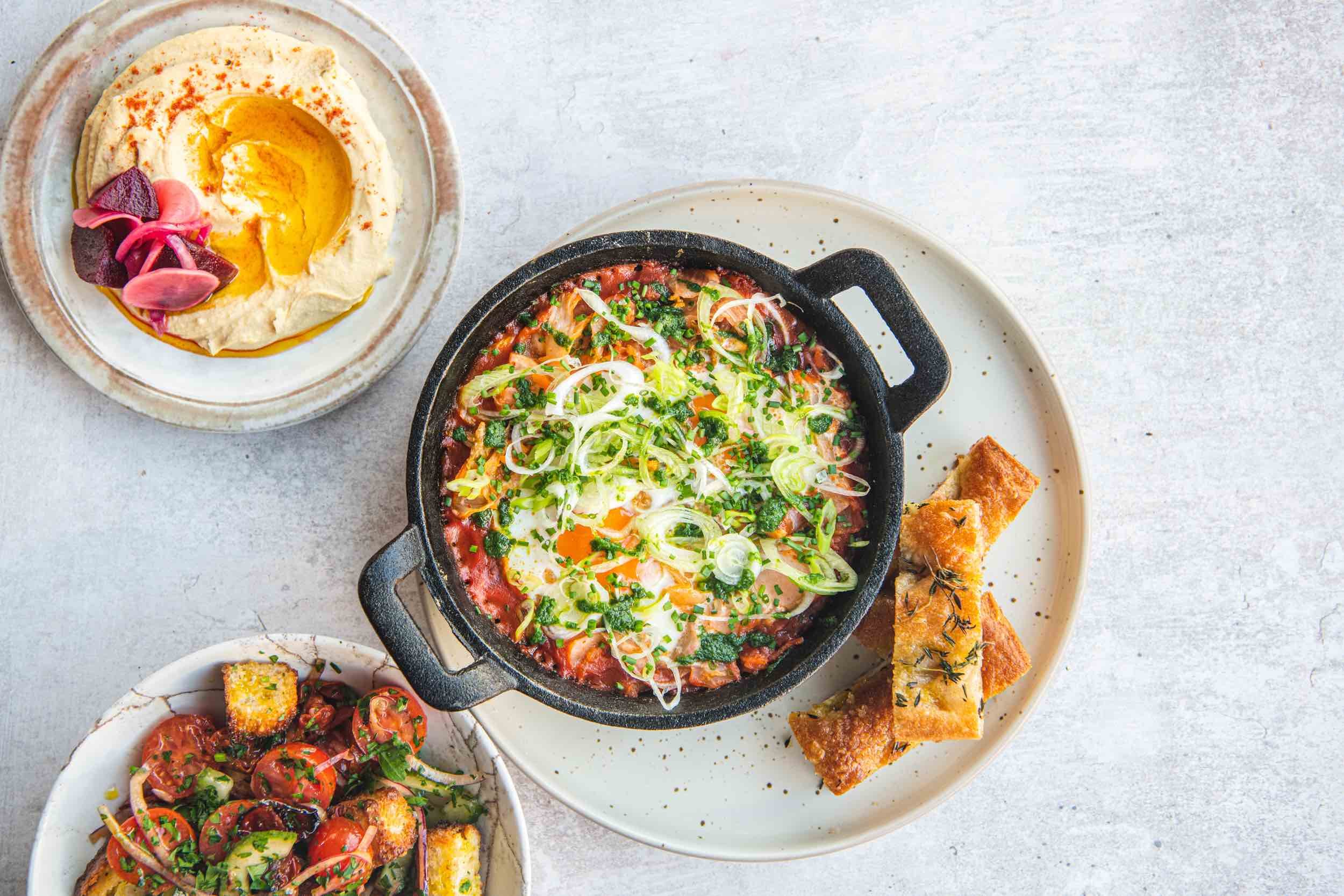 Kimchi shakshuka, hummus, panzanella.jpeg