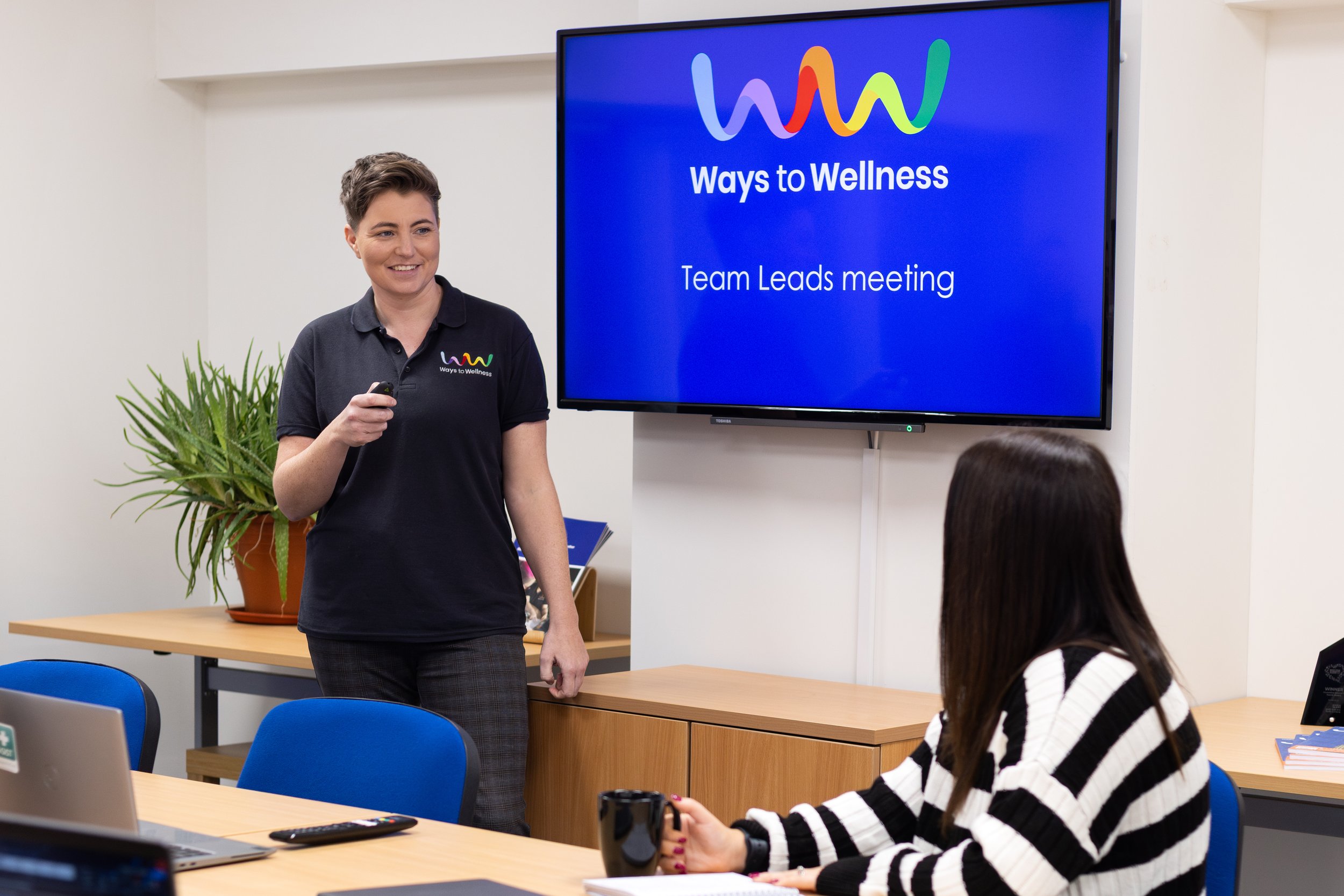 A woman standing in front of a presentation.