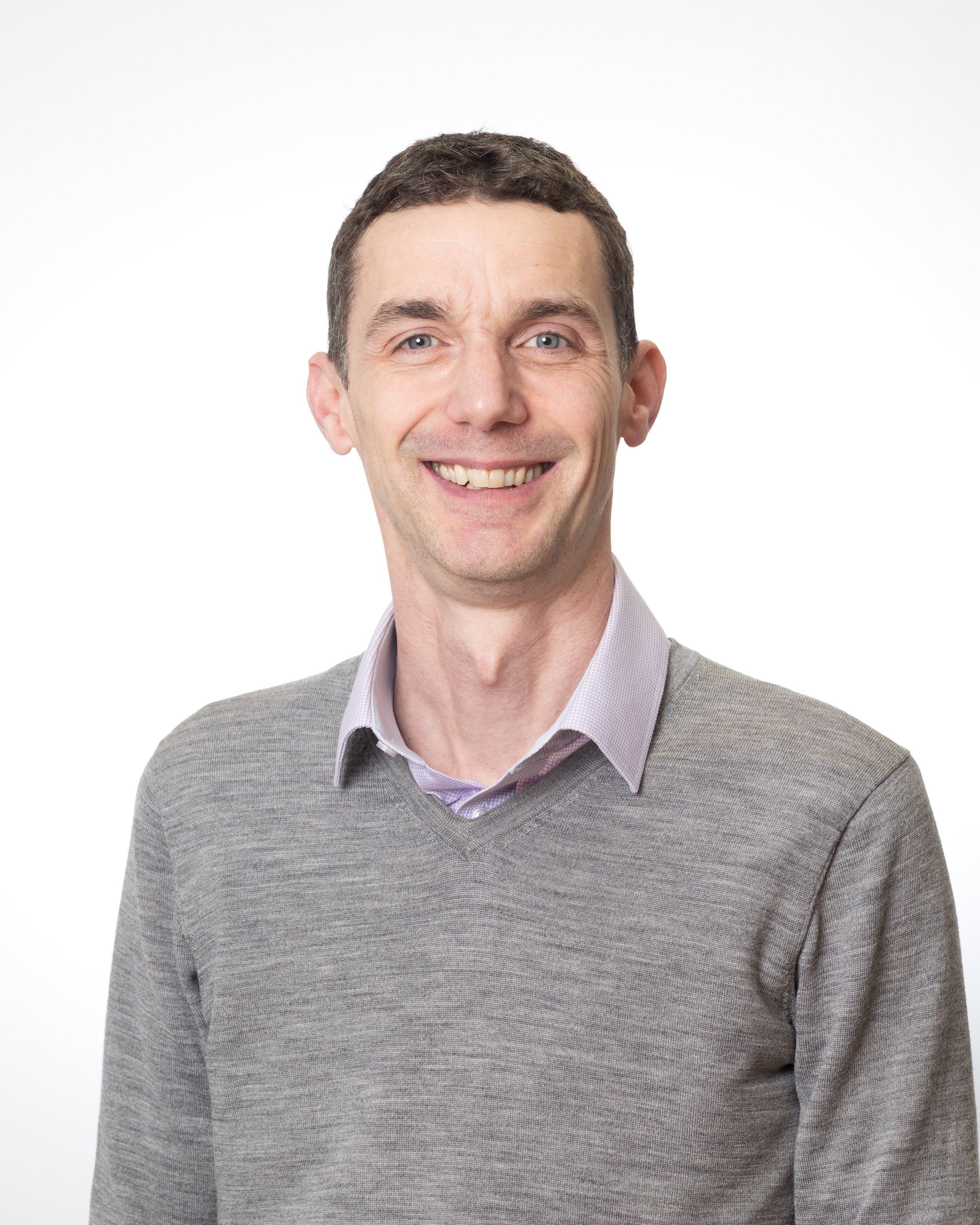 Photo of a slim middle-aged man in a pink shirt