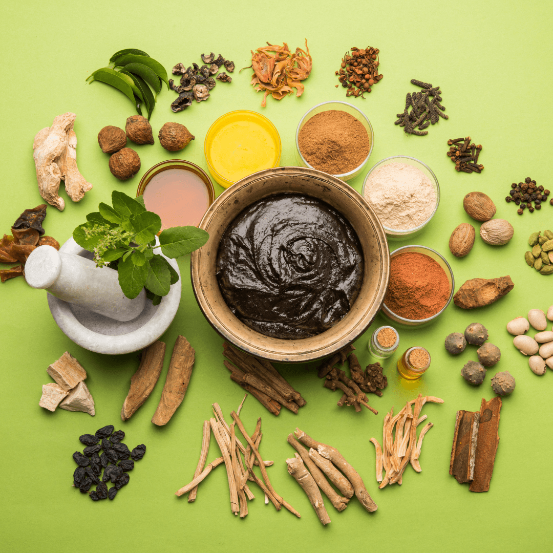 Image of ingredients including herbs, roots and barks with a pestle and mortar