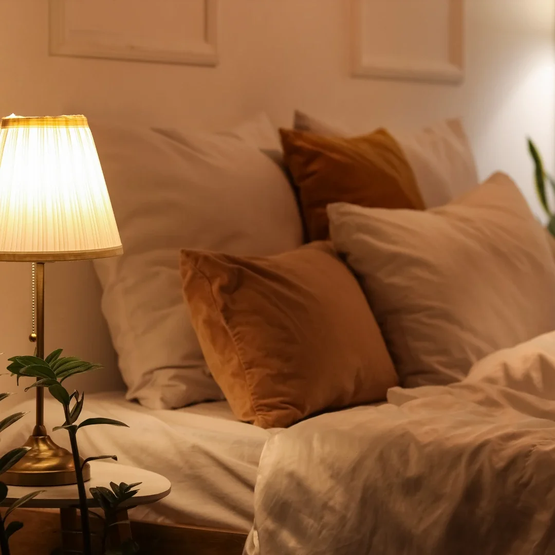 Image of cosy bed with night lamp beside it