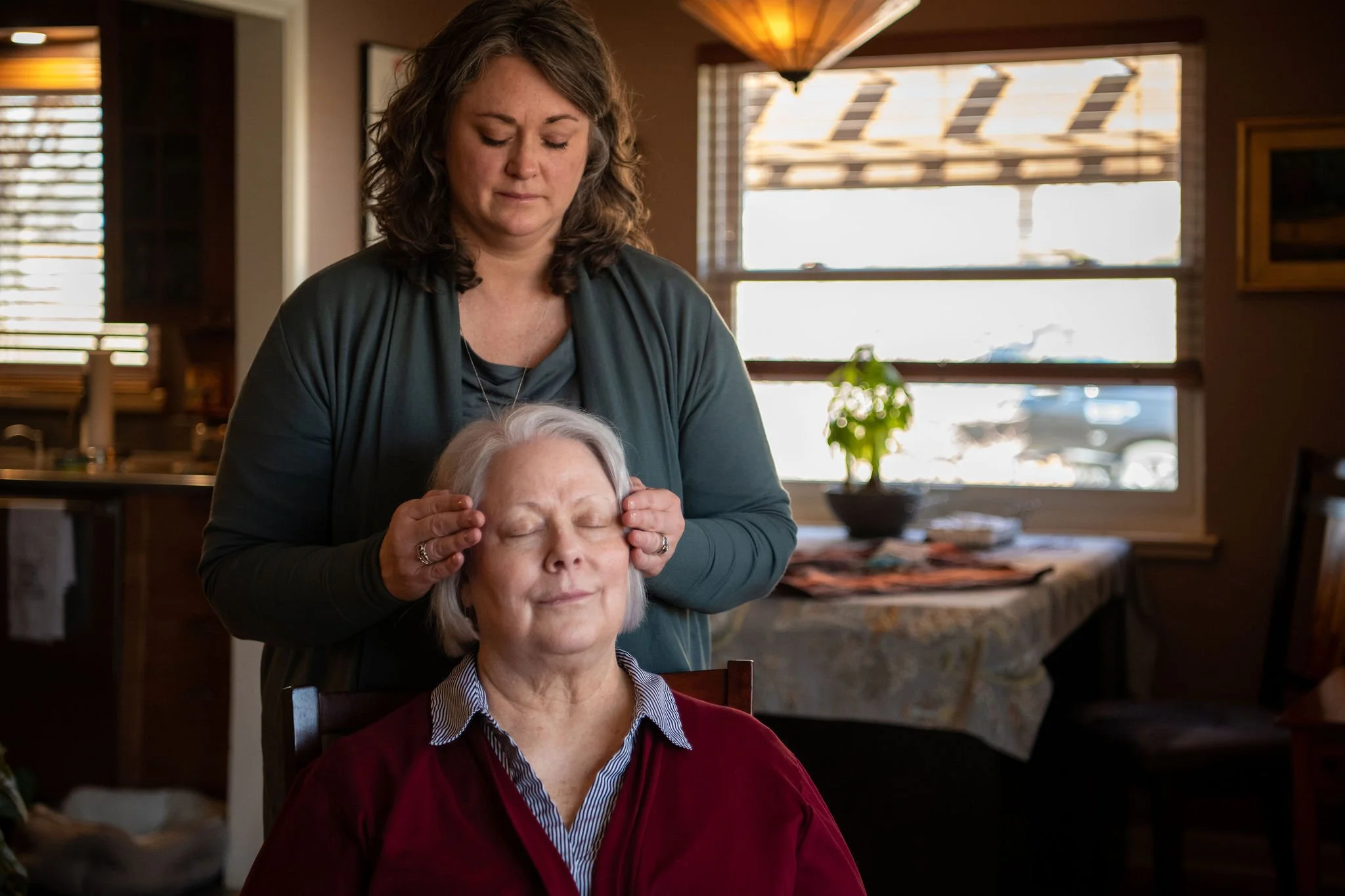person sitting peacefully with pet during companion connection session, receiving reiki