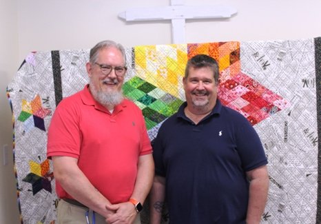 Gary and Rob in front of Gary's handmade quilt