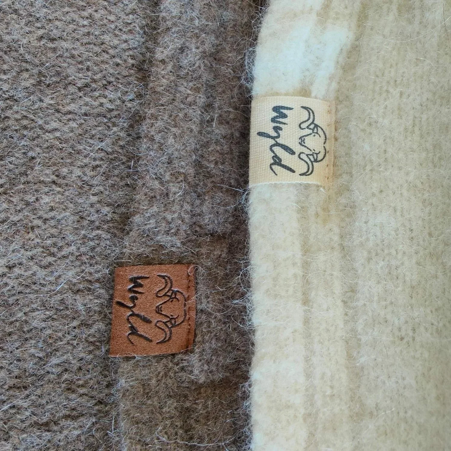 Close-up photo of fabric with two Wyld labels, one leather and one fabric