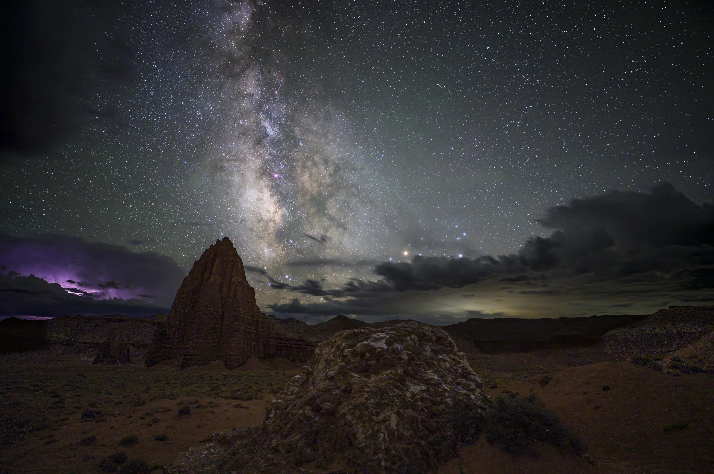 Milky Way galactic core rising above the red sandstone spire of Chimney Rock in Capitol Reef National Park, Utah