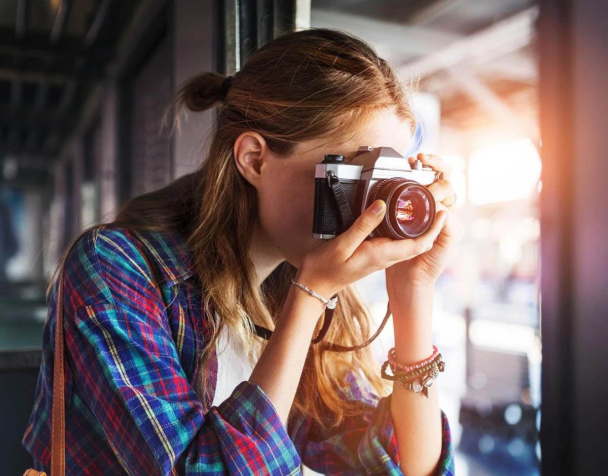 Woman shooting with a Canon camera