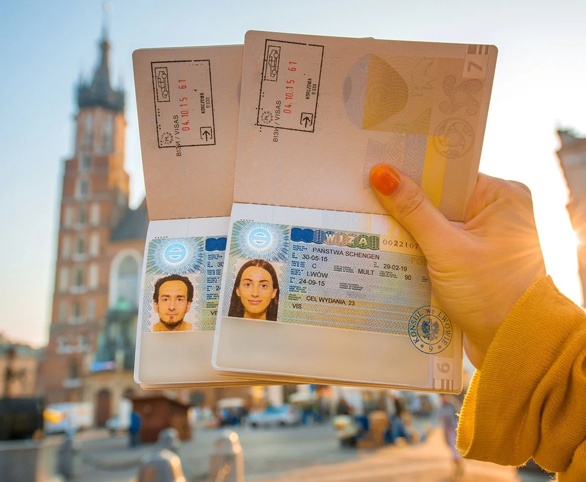 Hand holding two open passports