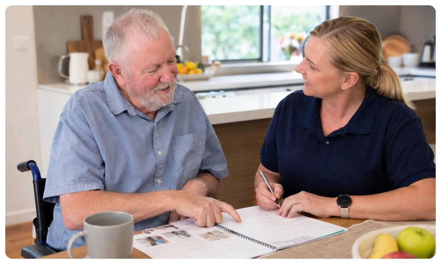 older disabled man chats with ndis coordinator in his home, disability support for over 65, ndis home care