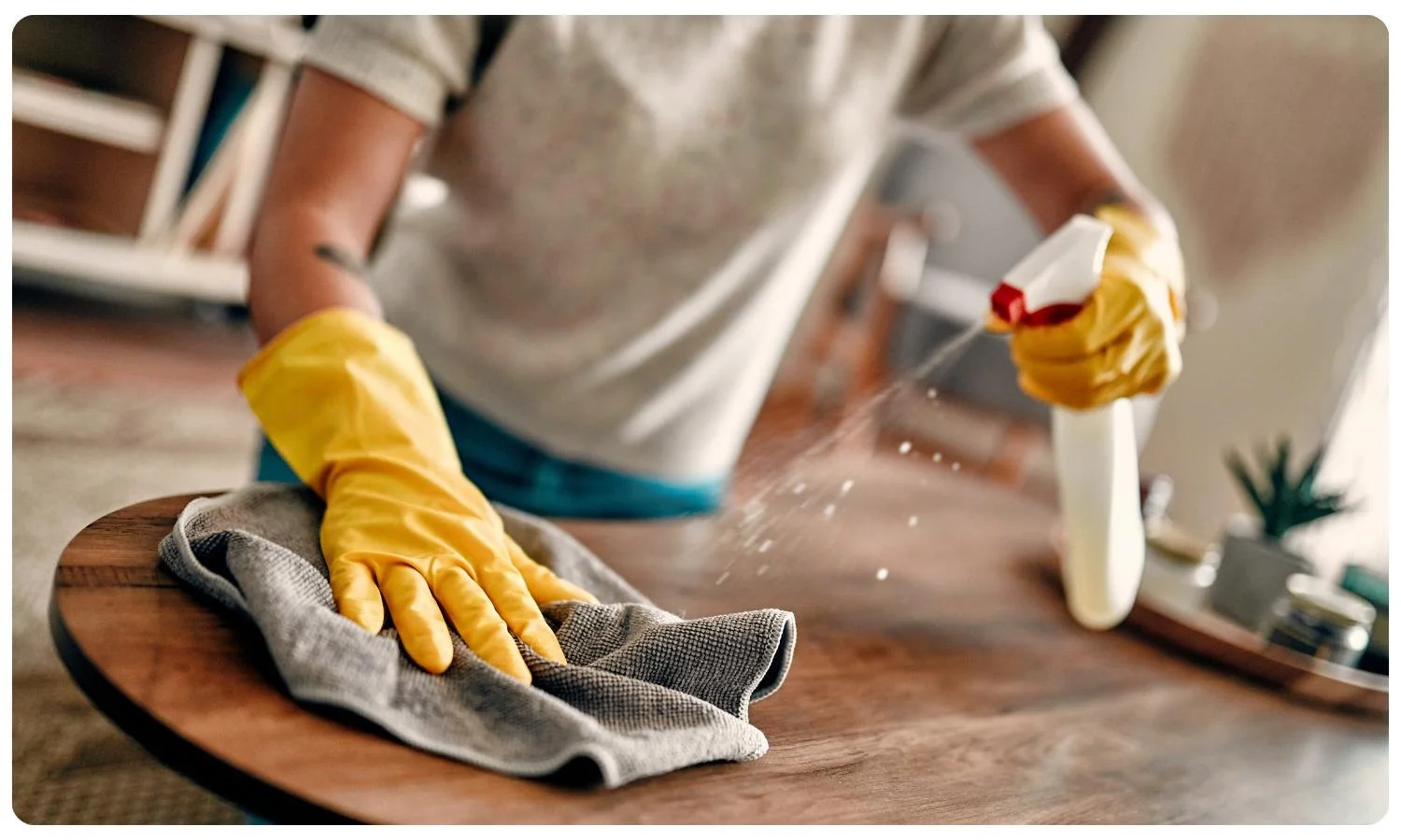 cleaner using a spray cloth to wipe table, cleaning services for elderly, cleaning elderly homes