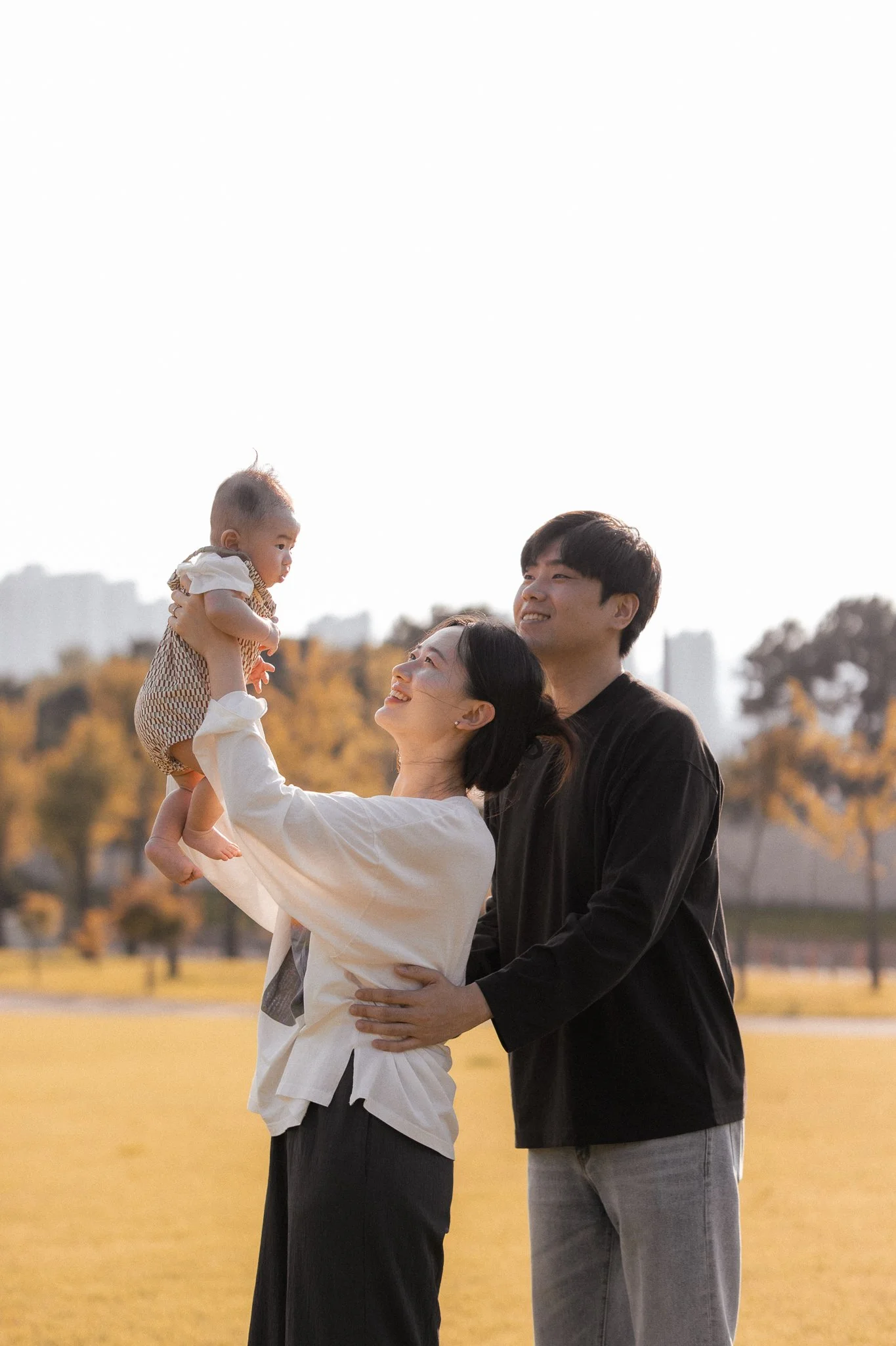 Family outdoors with baby on a sunny day