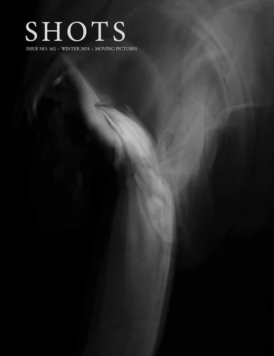 A black and white magazine cover of SHOTS magazine.