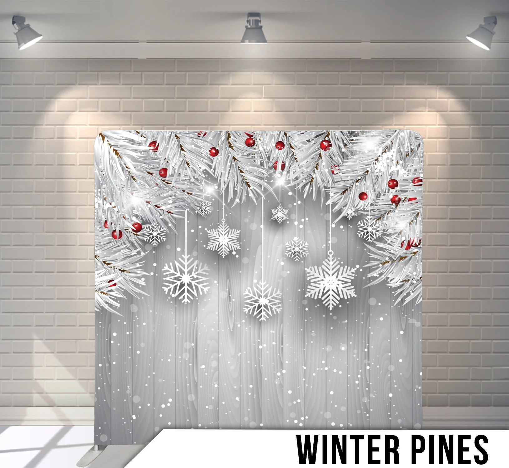 Winter-themed backdrop with white pine branches and red berries against a snowy background featuring large white snowflakes, under spotlights, with 'Winter Pines' text at the bottom.