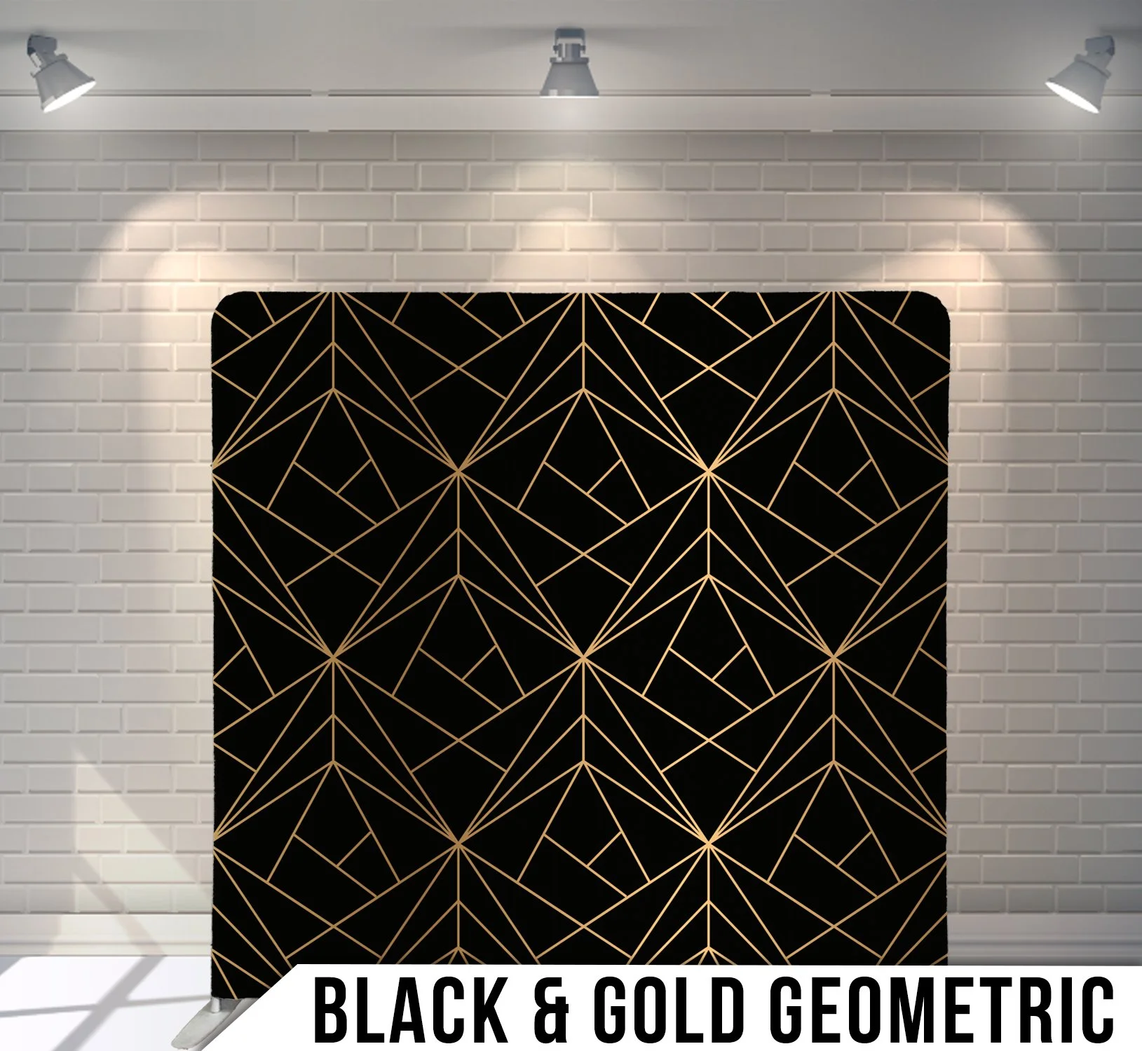 Black and gold geometric pattern on a display banner against a white brick wall.