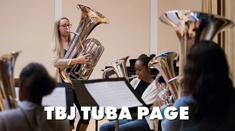Tuba player performing with a tuba section