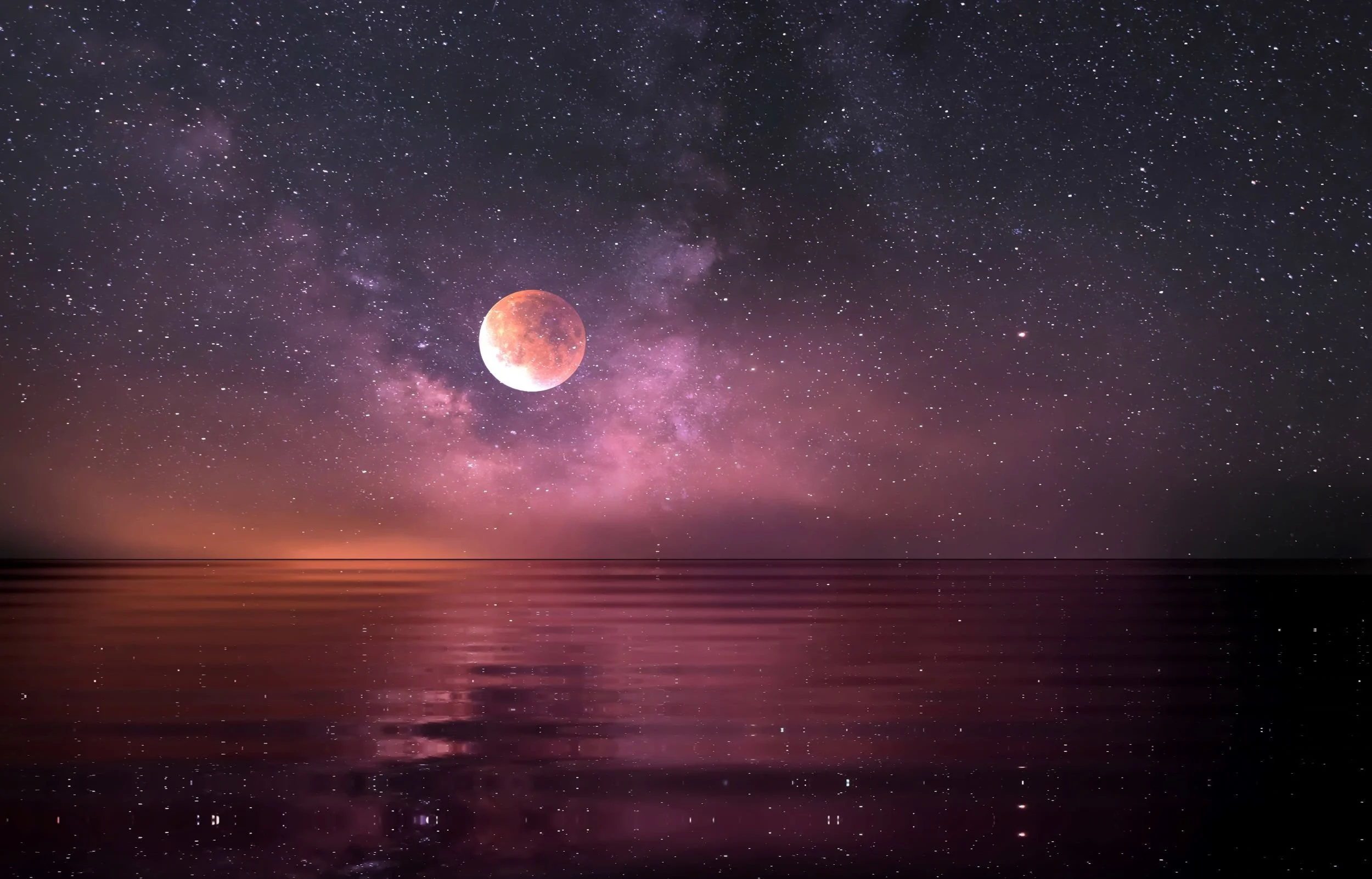 Orange Moon and magenta starry sky over rippling water below