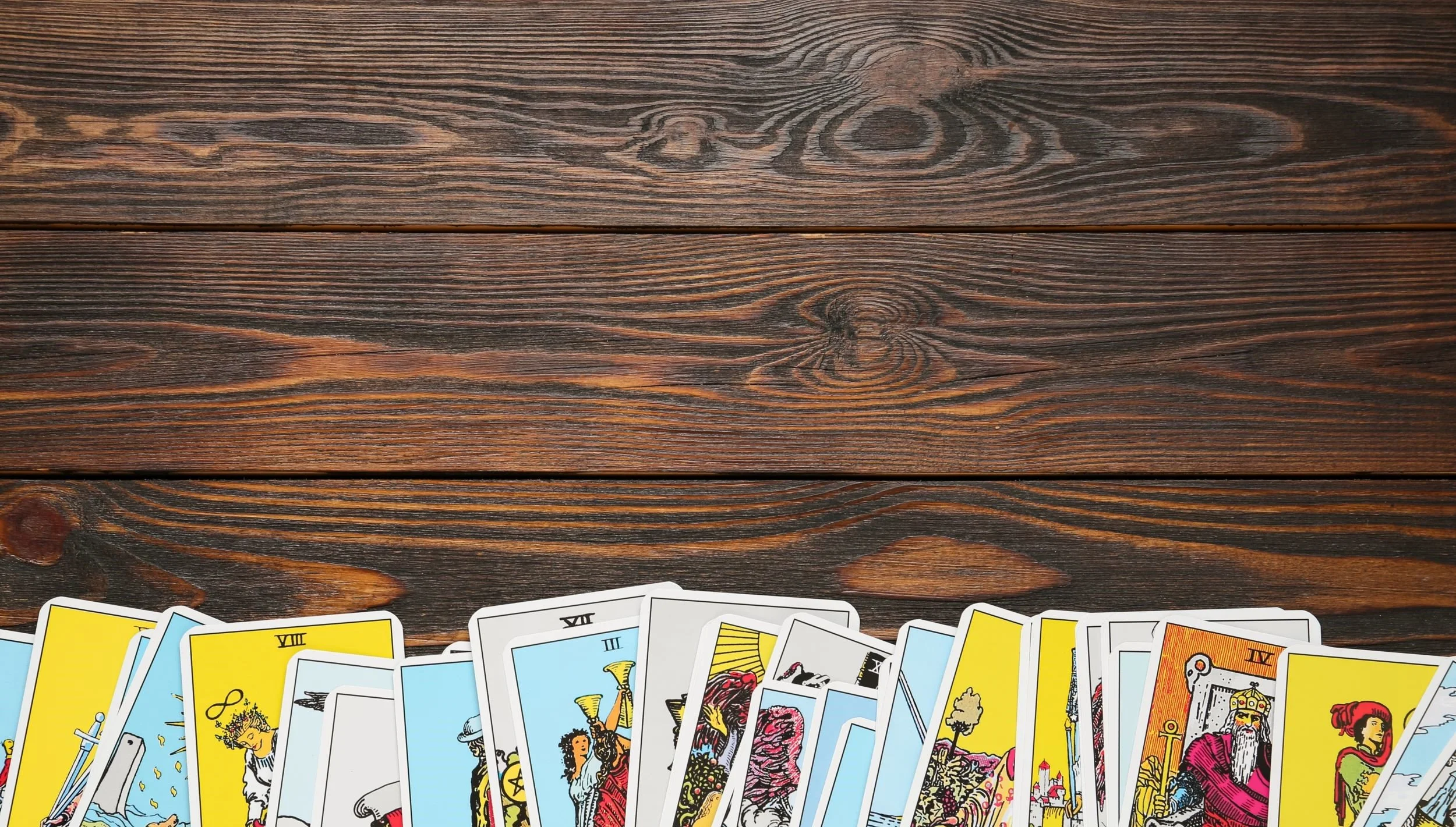 Tarot cards laid out on a wood table