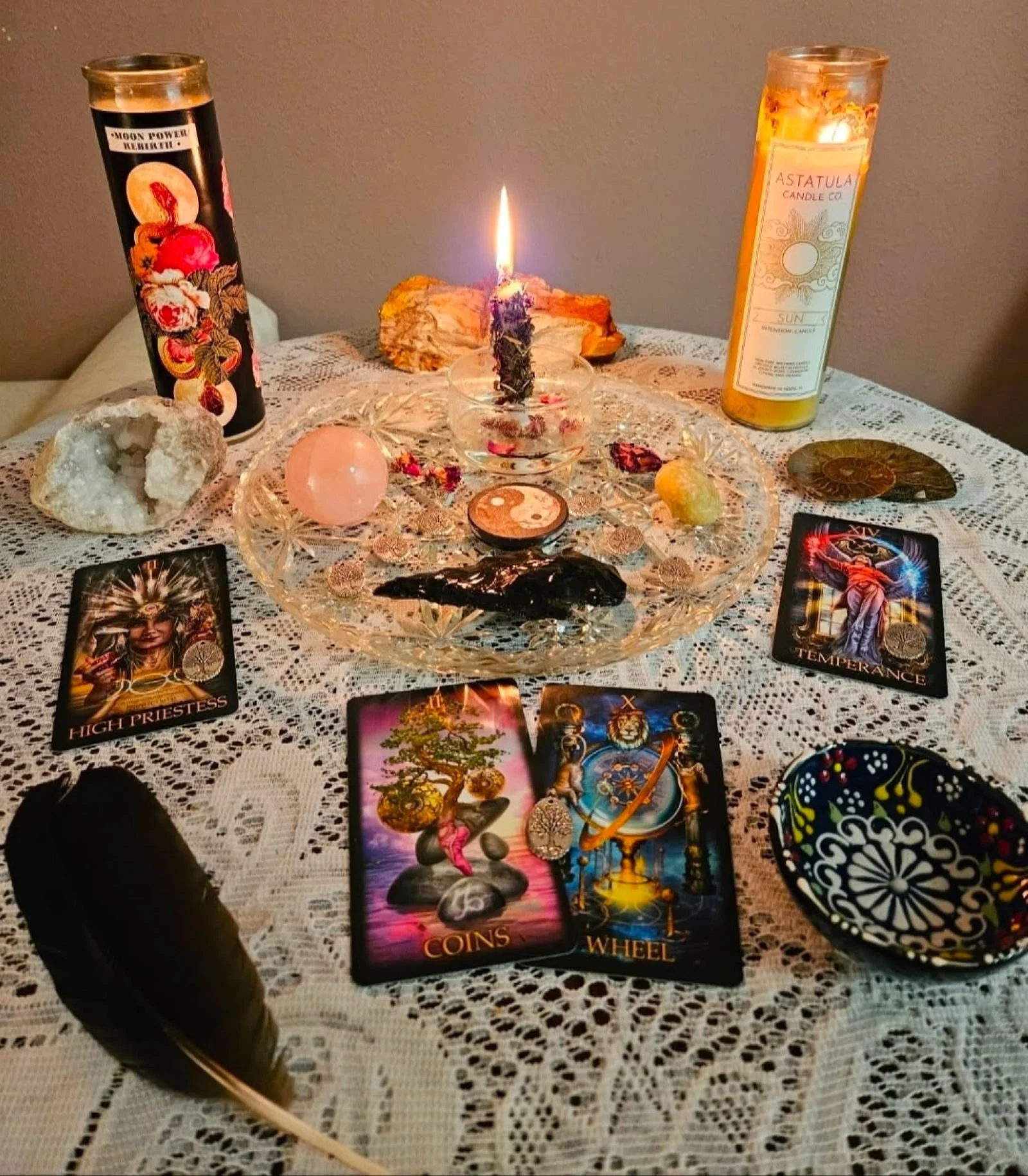 An altar with cards, lit candles, and other meaningful objects