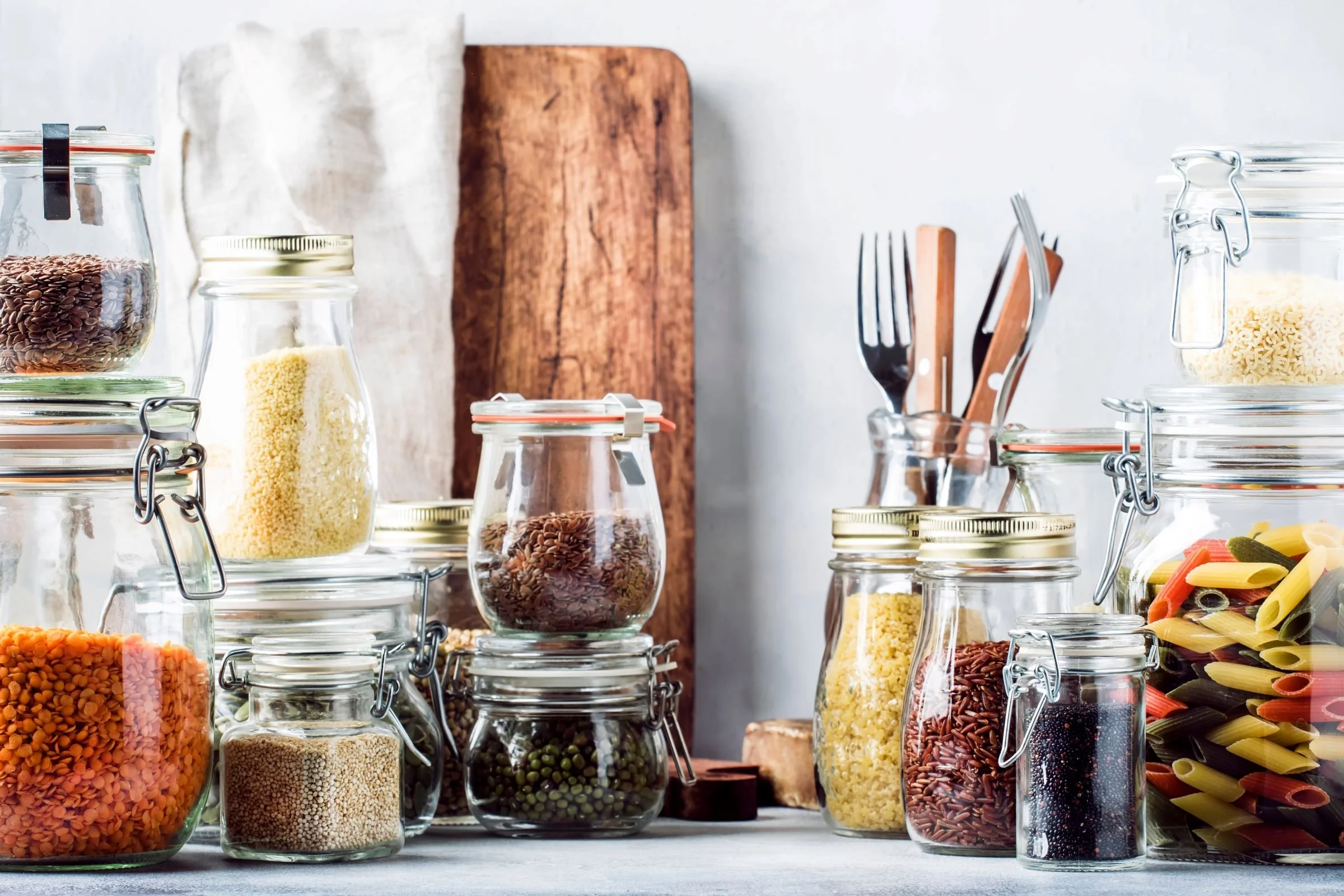 Jars of herbs and spices in white kitchen