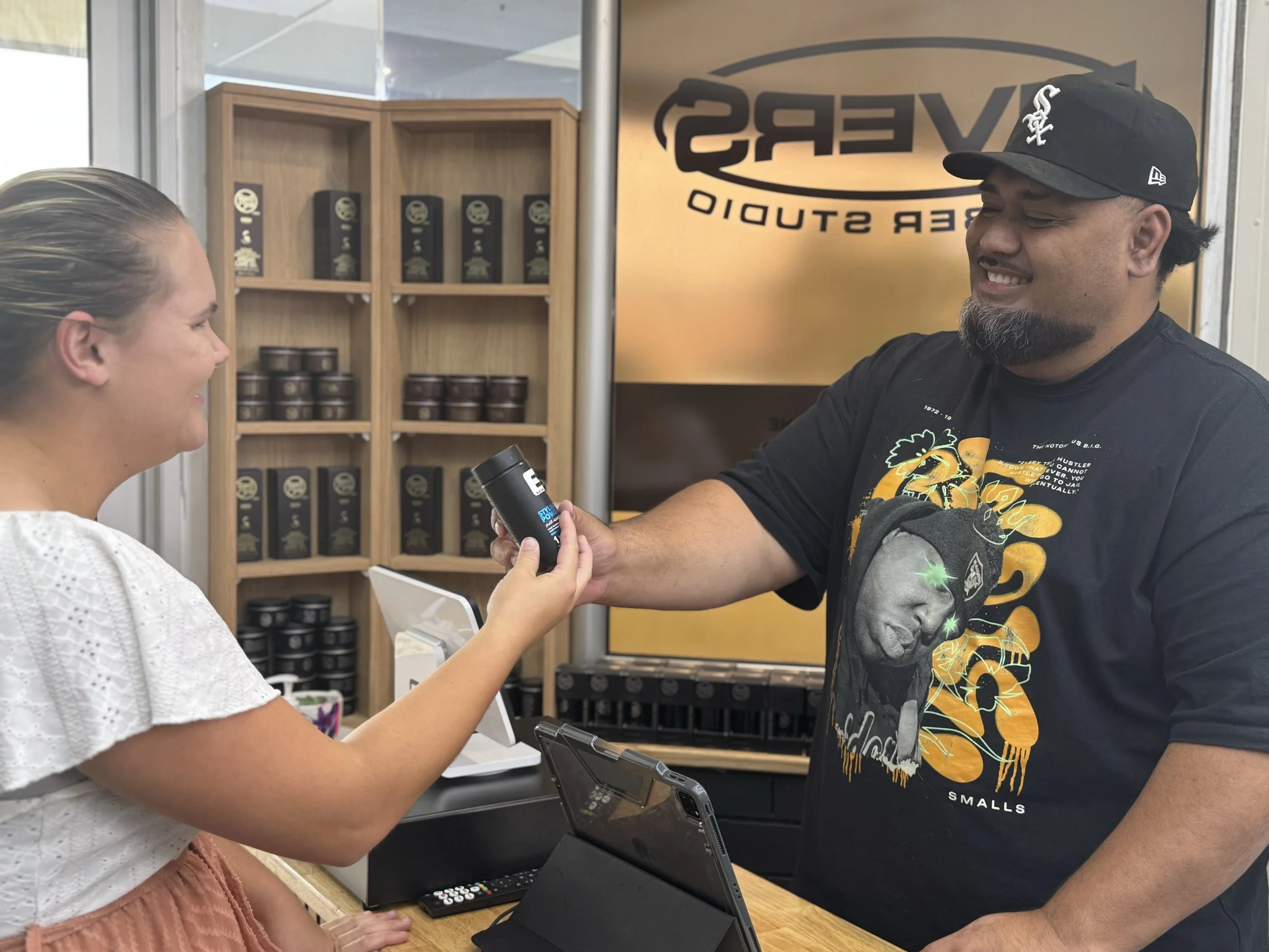 Our friendly barber, Damon helping a customer at the barber checkout counter.