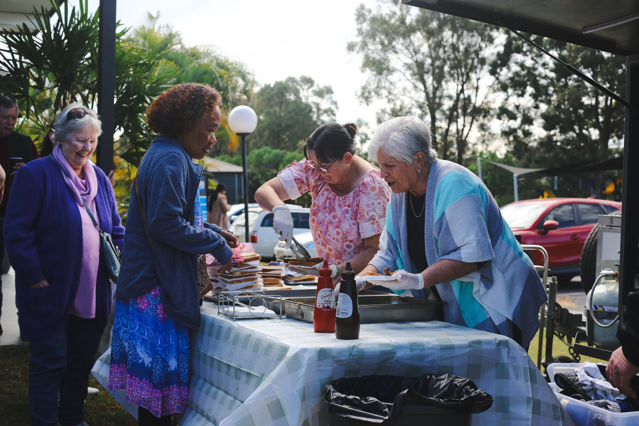 volunteers helping at a function sausage sizzle