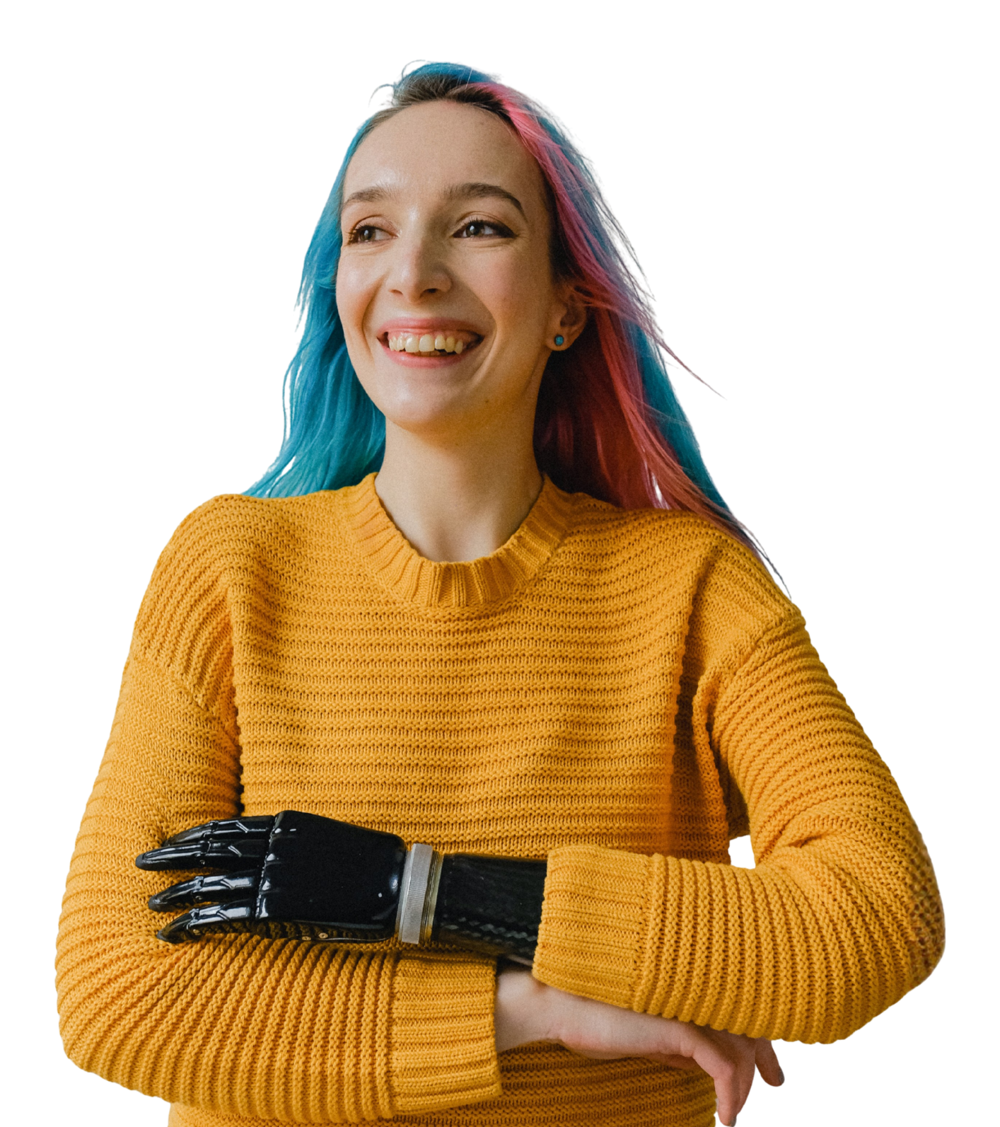 A woman with long, colorful hair smiling, wearing a mustard yellow sweater and prosthetic hand.