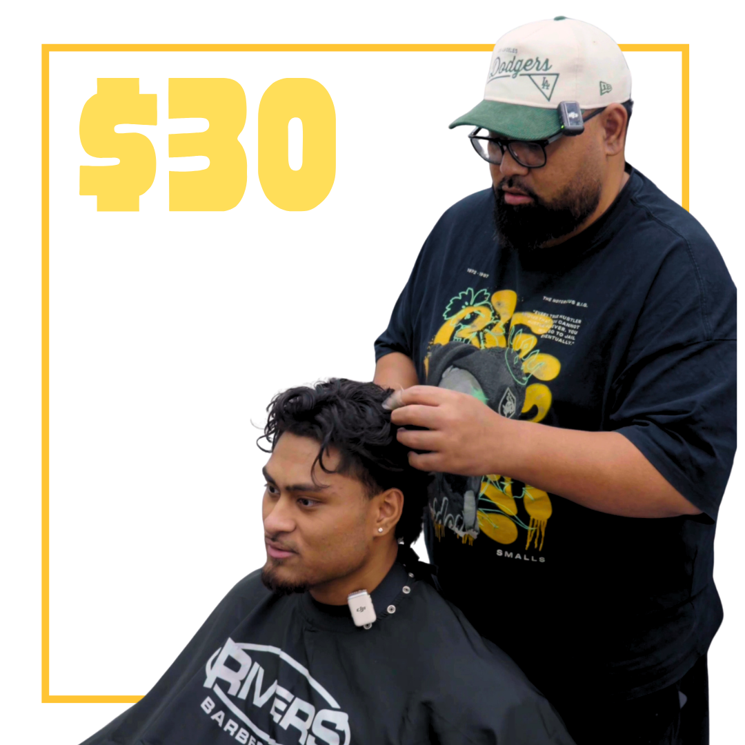 Barber giving a haircut to a male client inside a barber shop, with text saying $30 mens cut