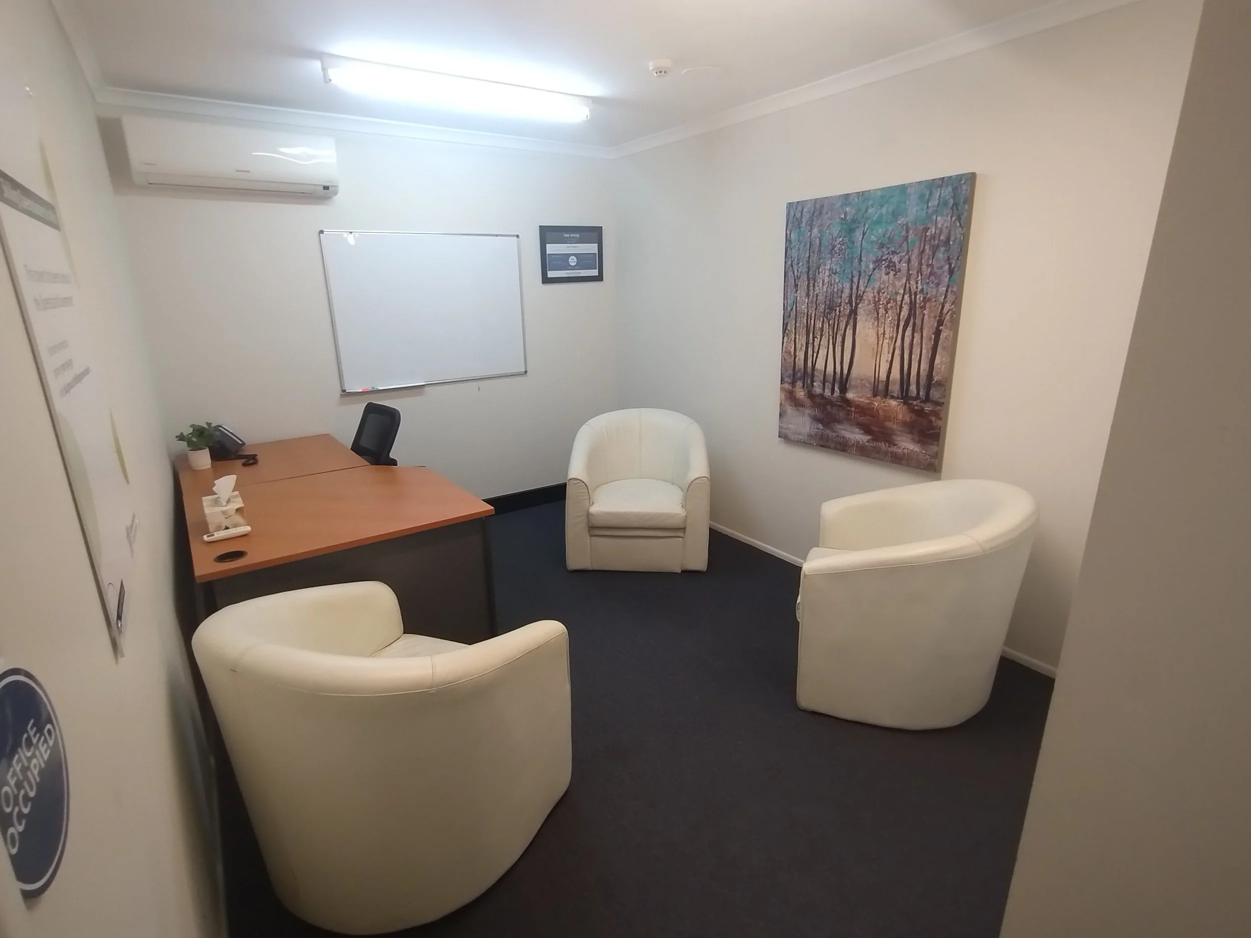 Office with desk and seating