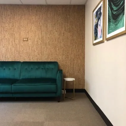 A green couch inside of a counseling room at Shift Counseling, PC