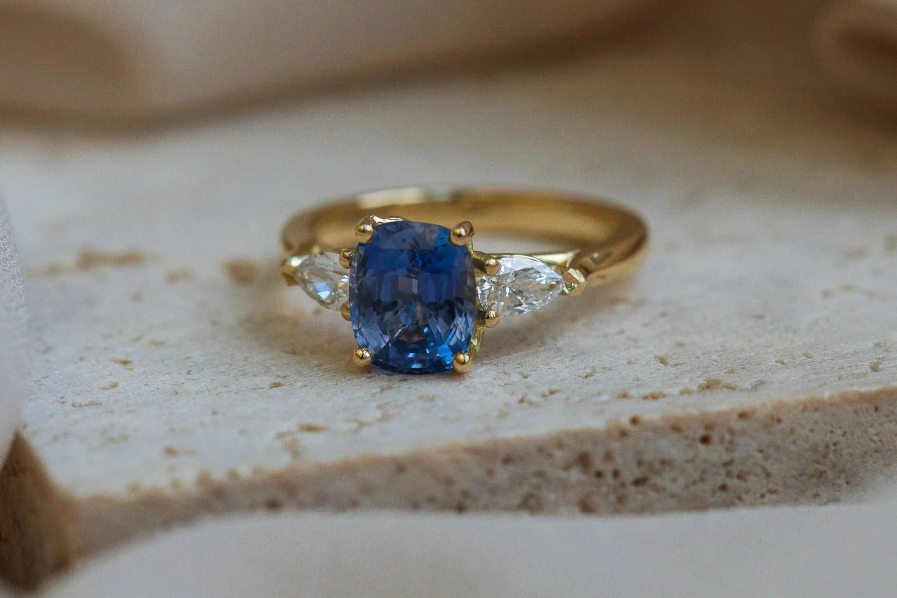 Heulwen-Lewis-Bespoke-Cushion-Sapphire-Pear-Diamond-Trilogy-Leaf-Engagement-Ring